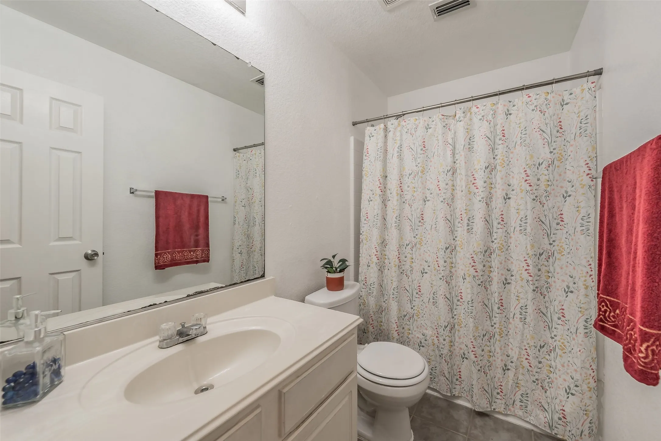 Hallyway bathroom offers shower and tub combo