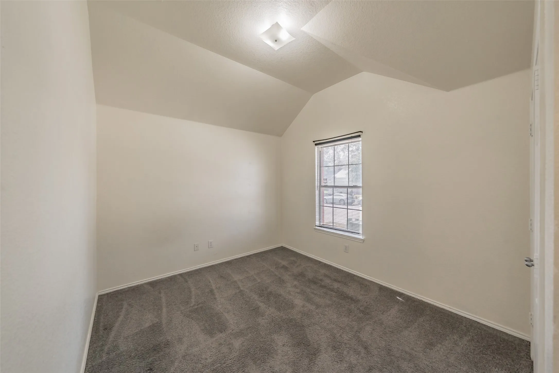 Bedroom two features a window overlooking the front yard.