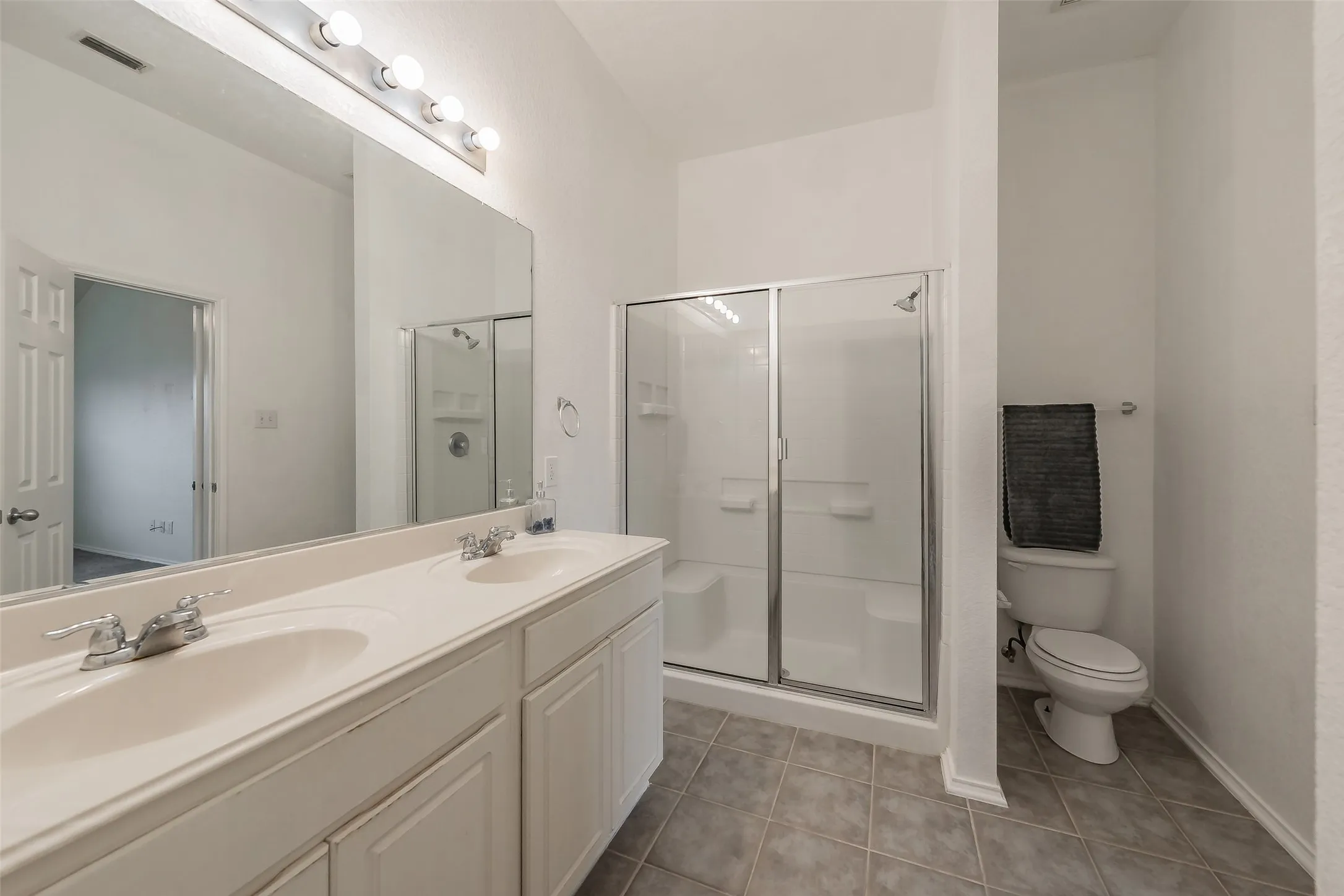 Master bathroom offers a walk-in shower with sitting bench