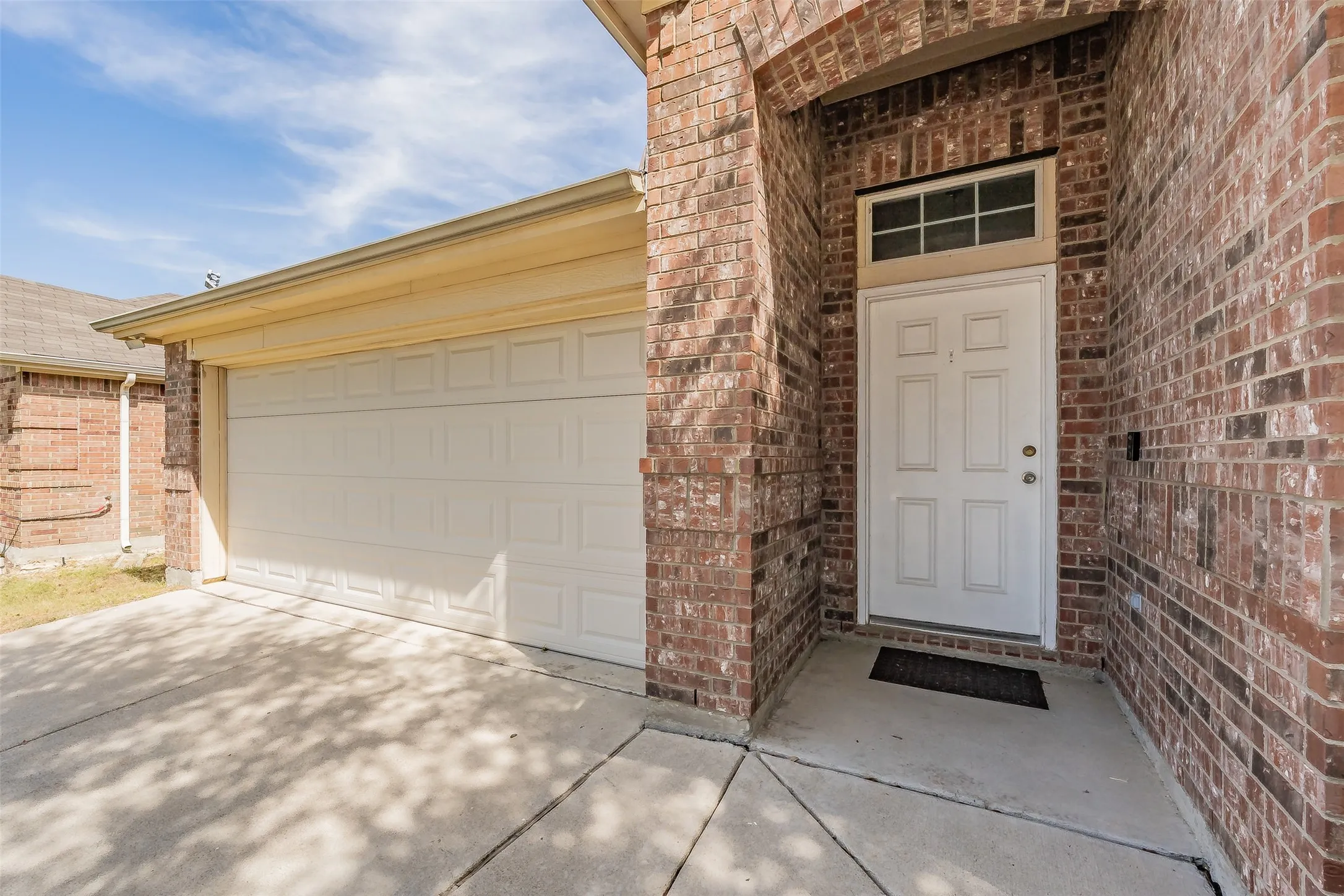 Covered entry with plenty of concret walking area,added window on top of door offering natural lighting.