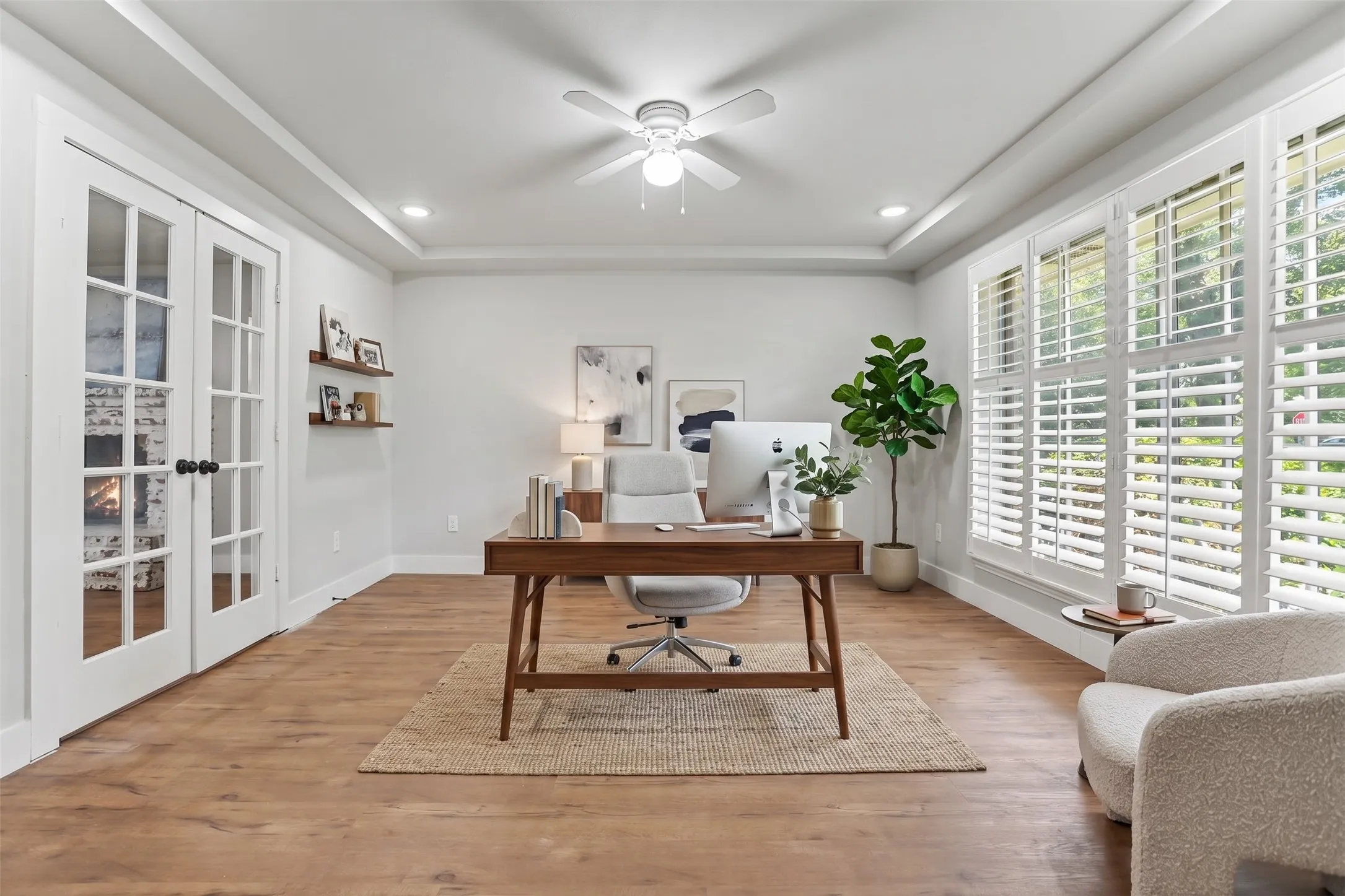 Virtually staged Tray ceiling with recessed lighting and a ceiling fan