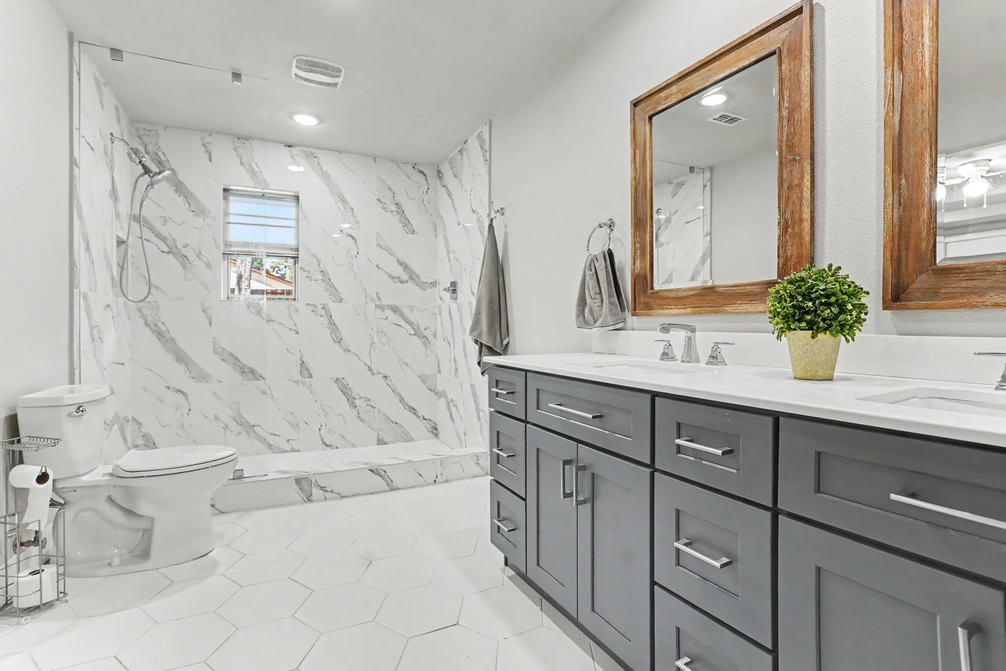 Dual vanity with gray cabinetry and white countertops
