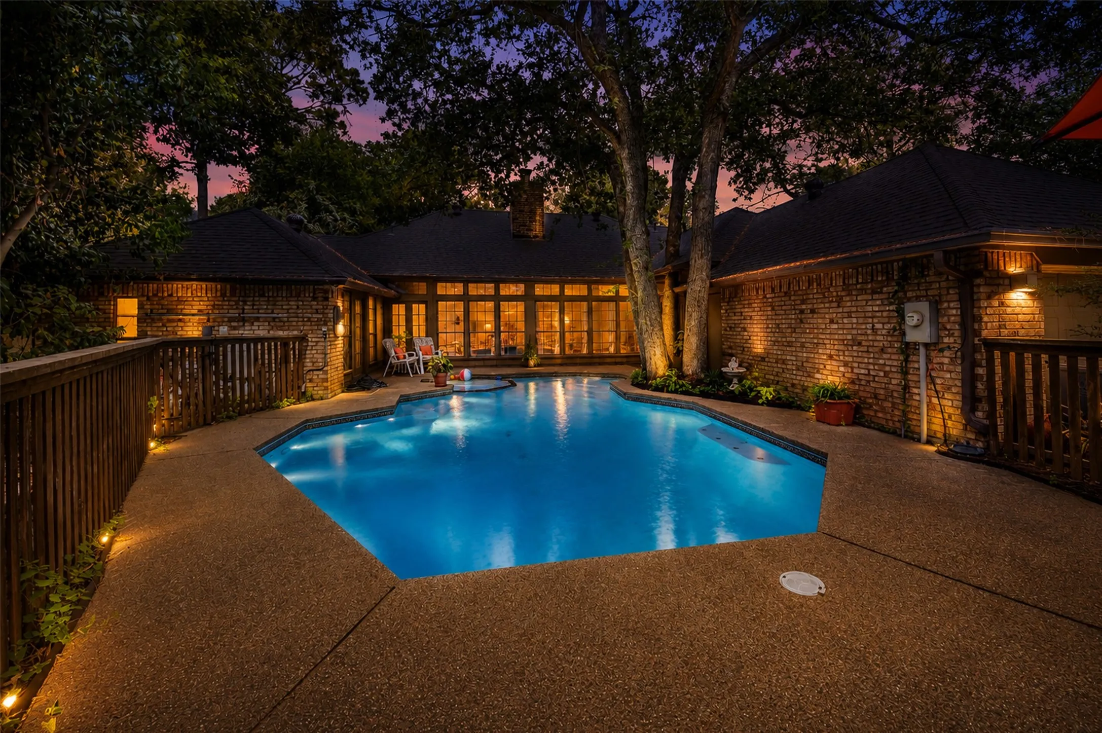 A view of the pool with evening lighting.