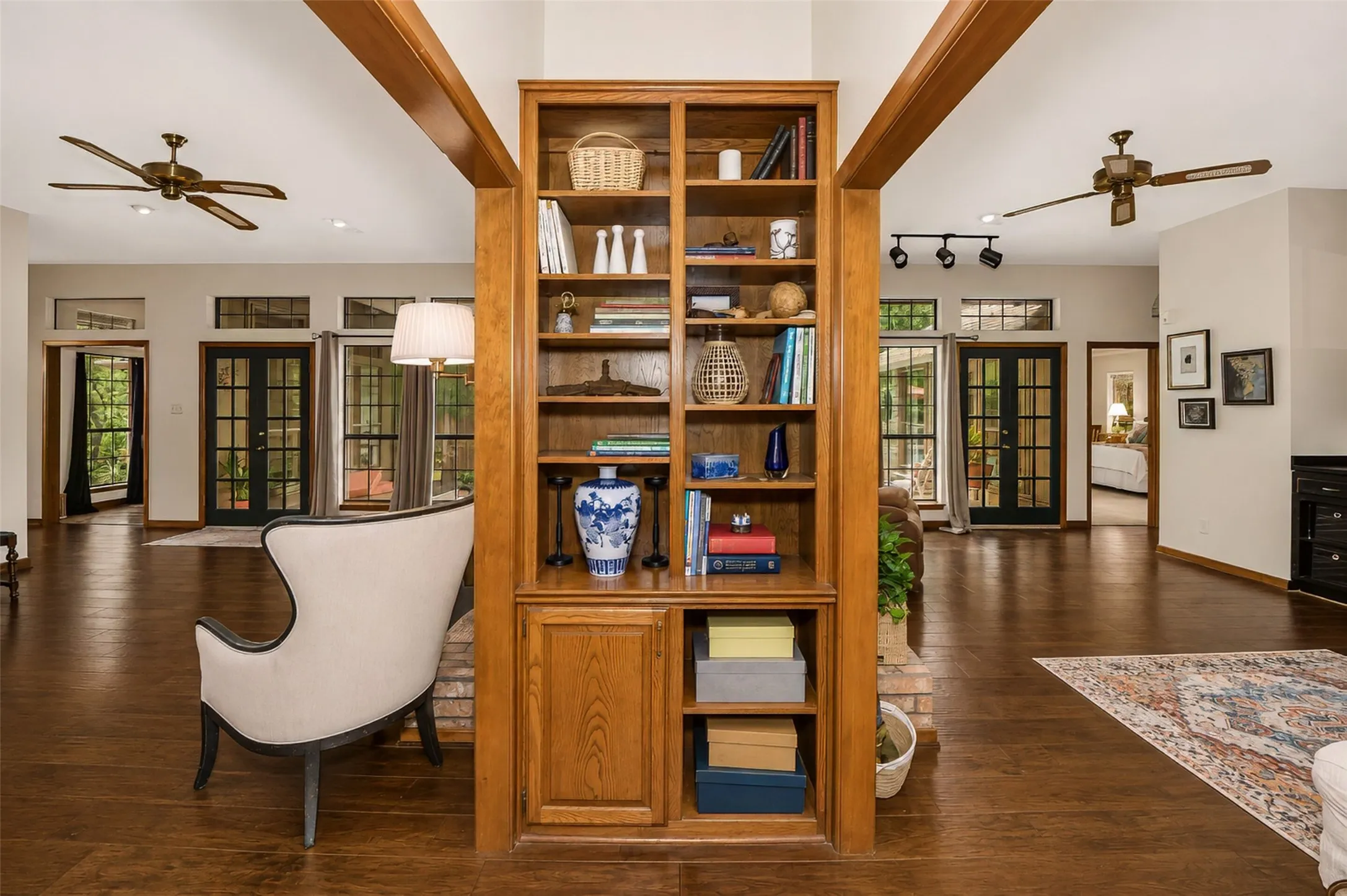 A built in bookshelf between living and family room areas.