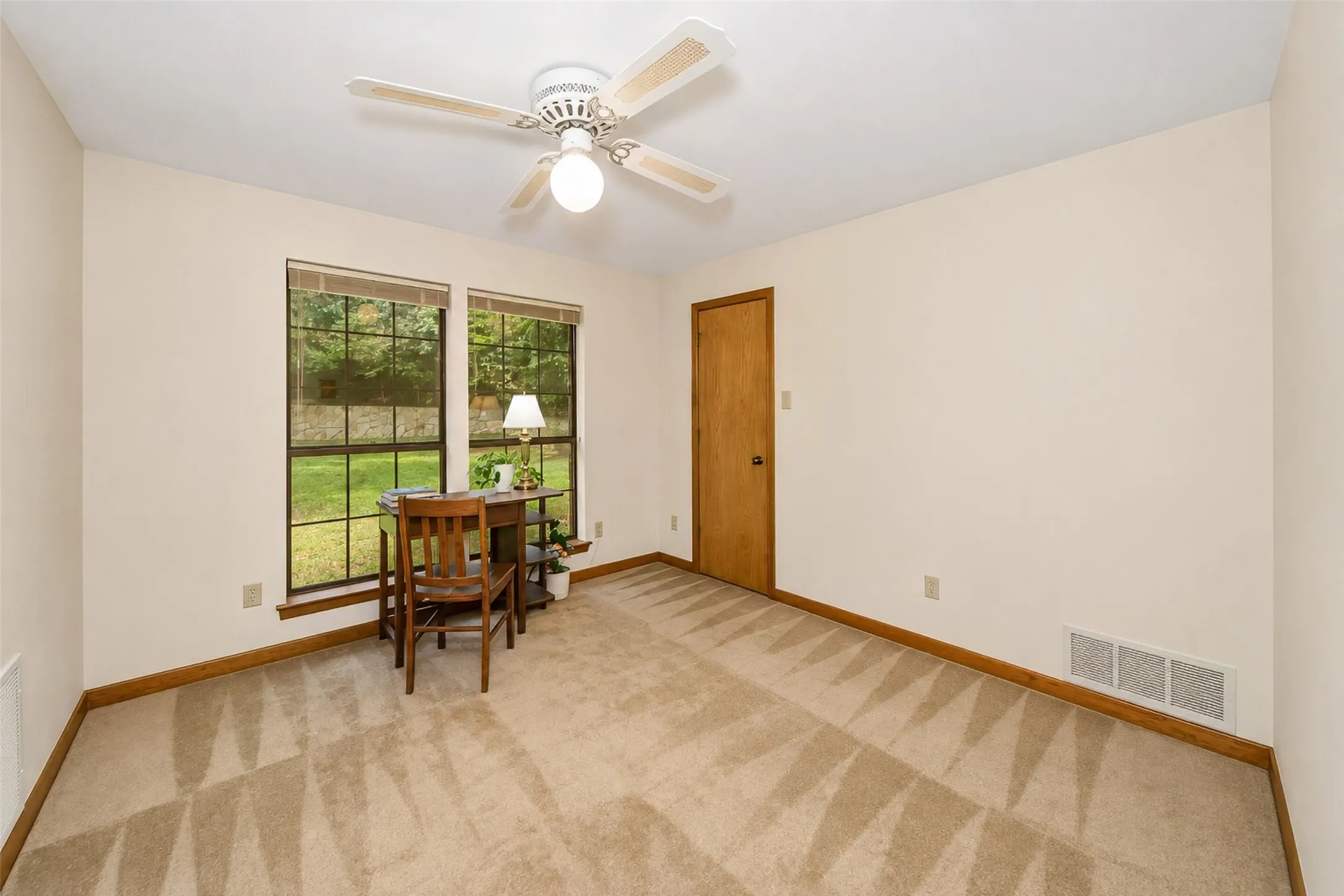 All bedrooms enjoy large windows looking out on lush vegetation and trees.