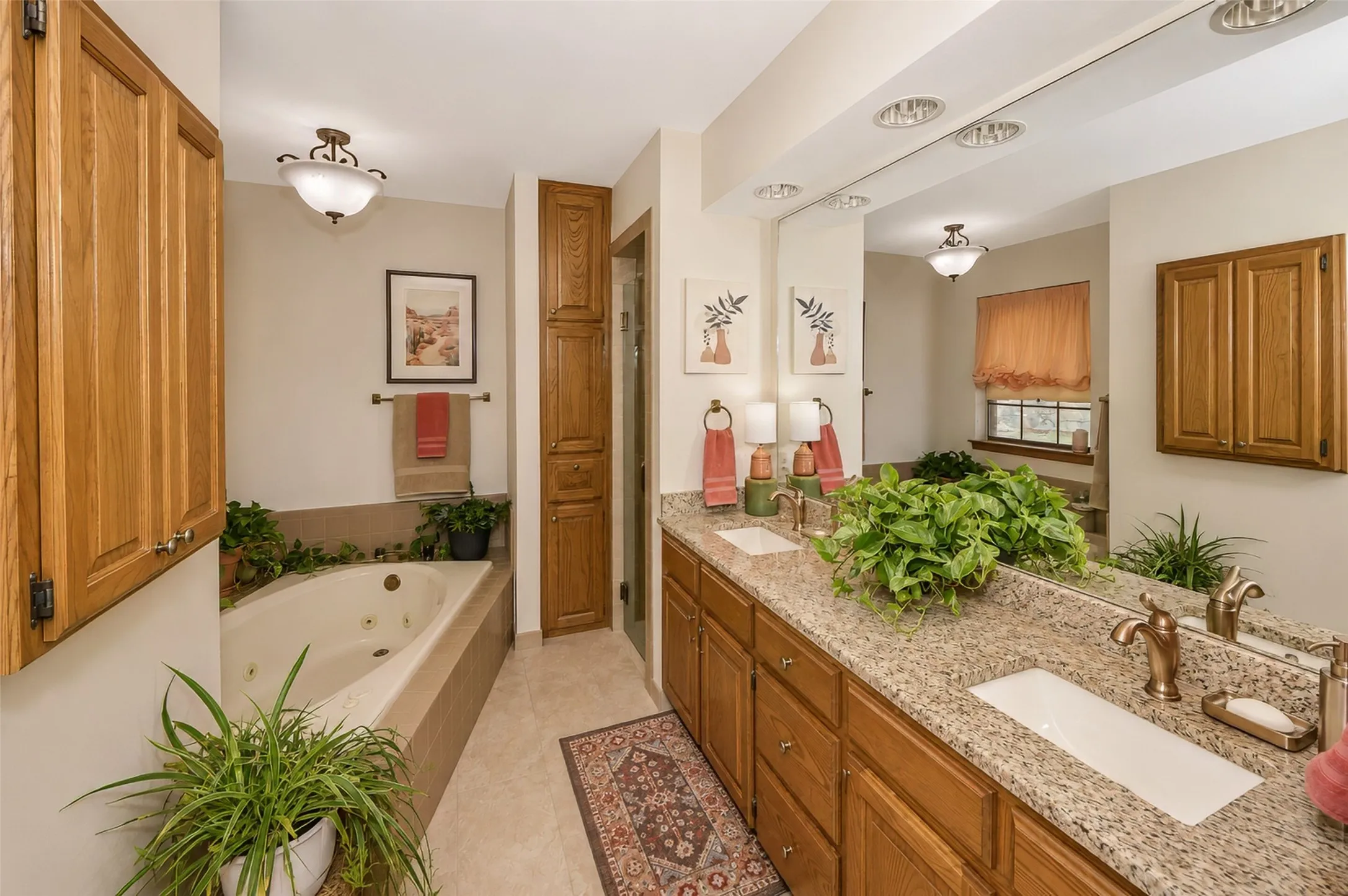 Lovely updated primary bath features separate garden tub, two vanity sinks and a separate shower.
