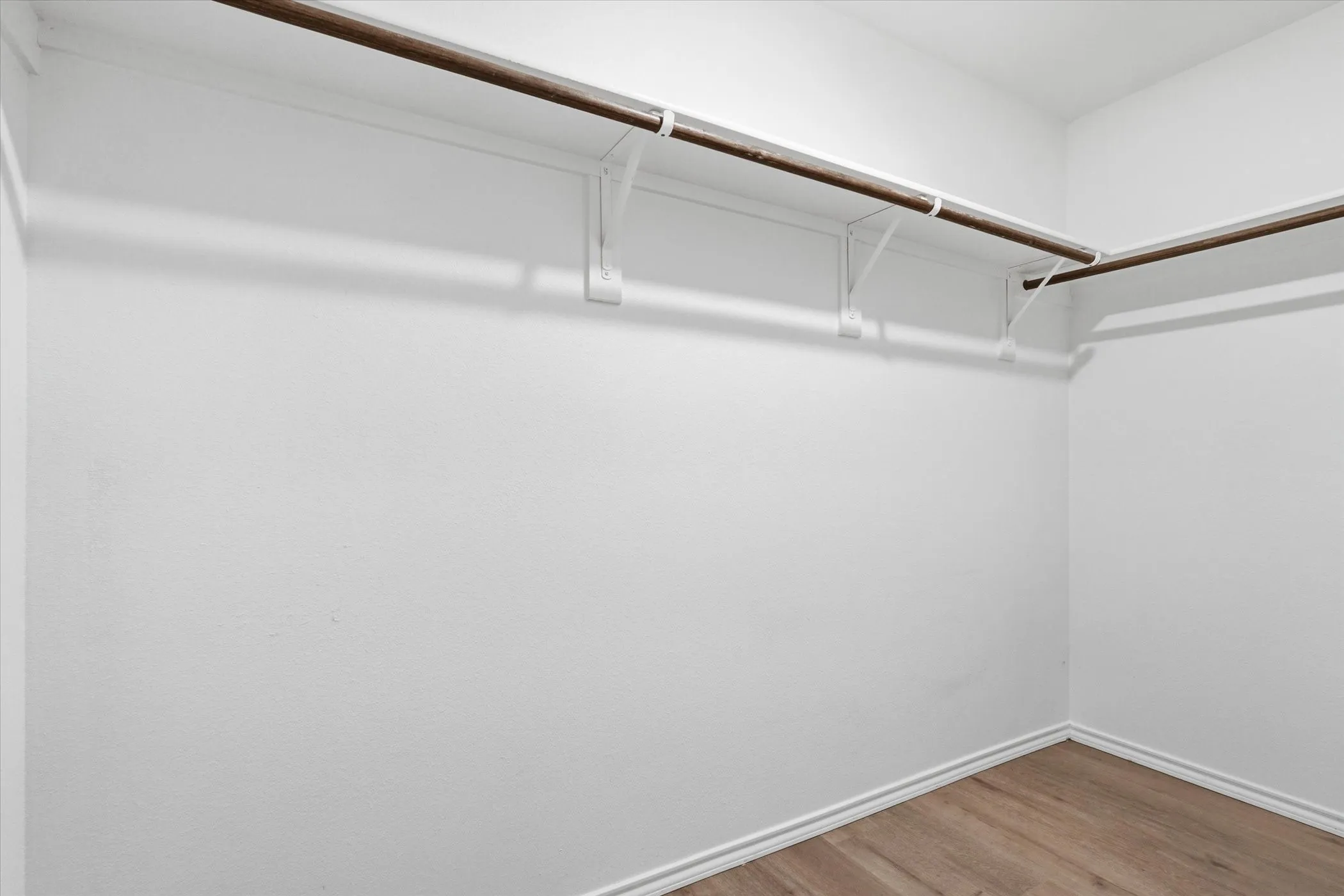 Hardwood-finish flooring, recessed lighting, and crisp white trim