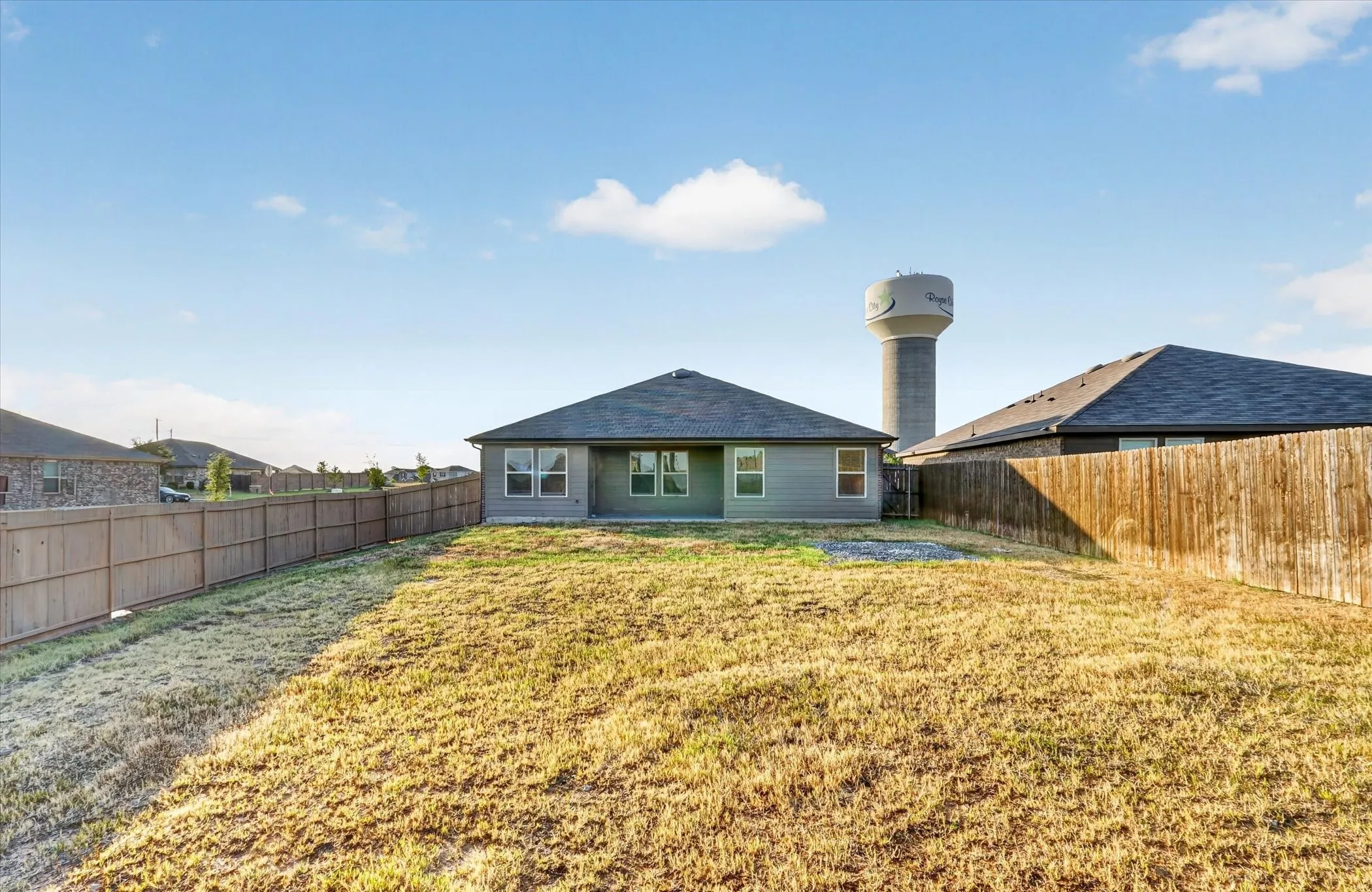Expansive backyard featuring a partial wood fence