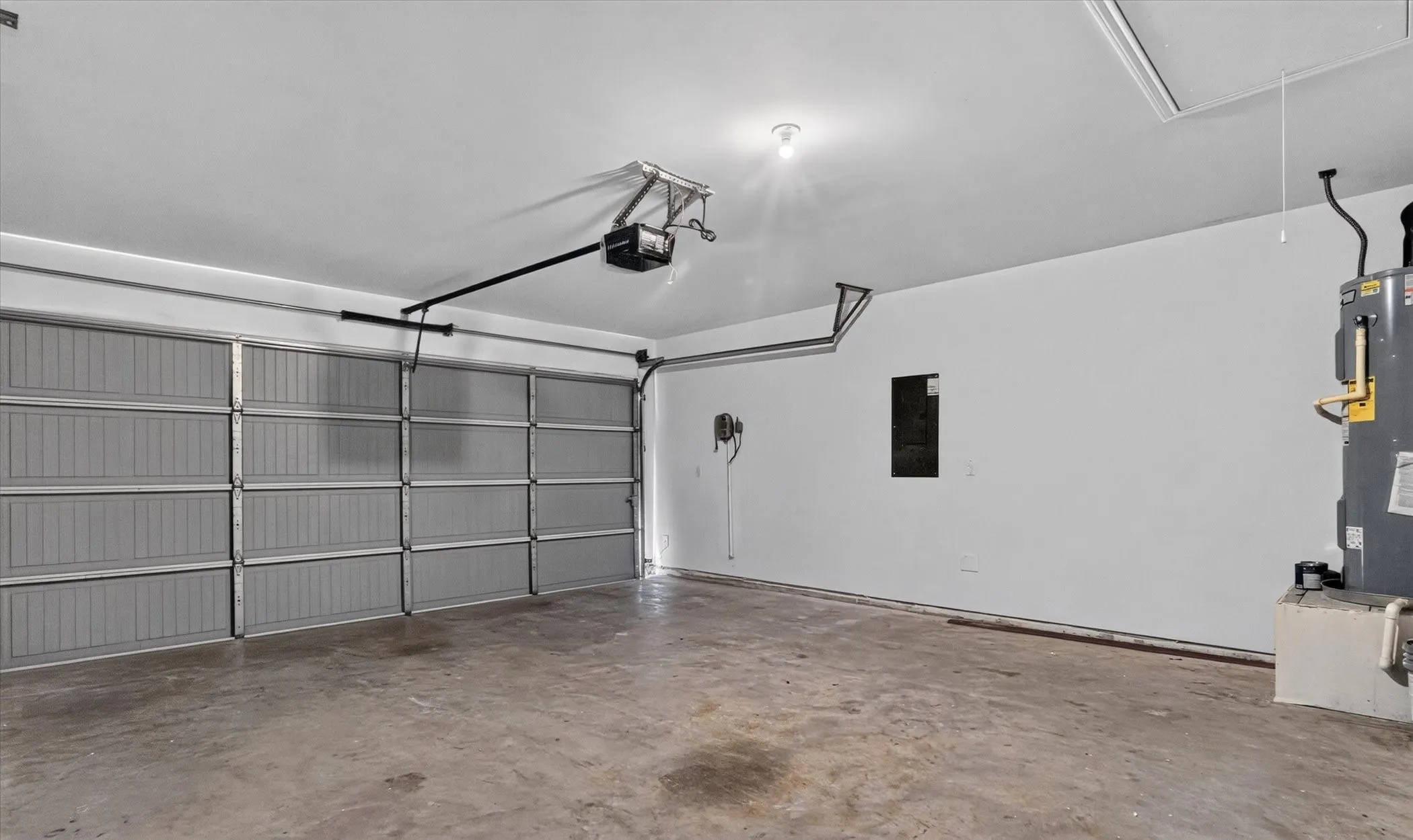 Two-car garage with concrete flooring and overhead lighting