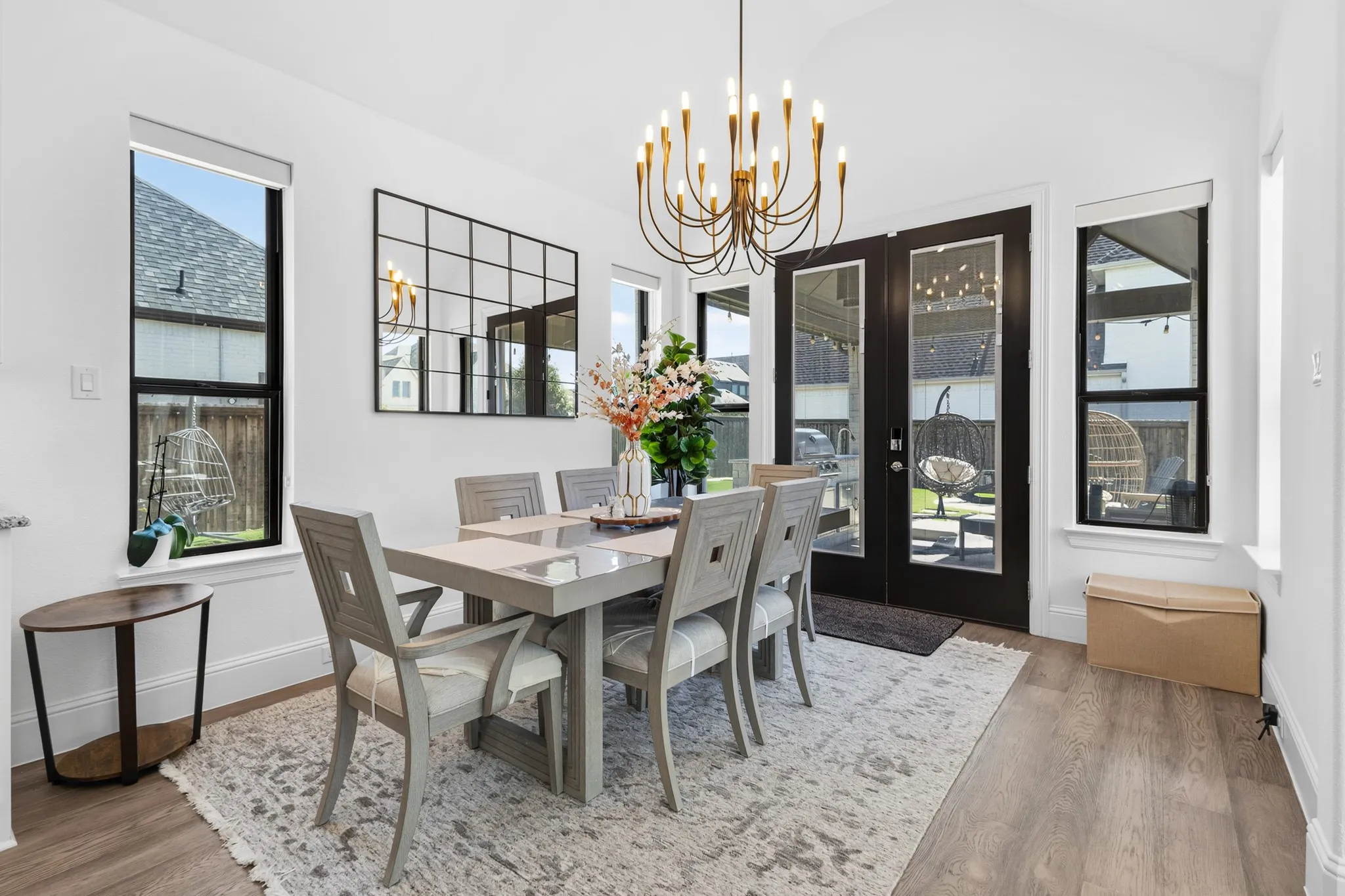 Vaulted ceiling accentuates the elegant chandelier, complemented by multiple windows providing natural light