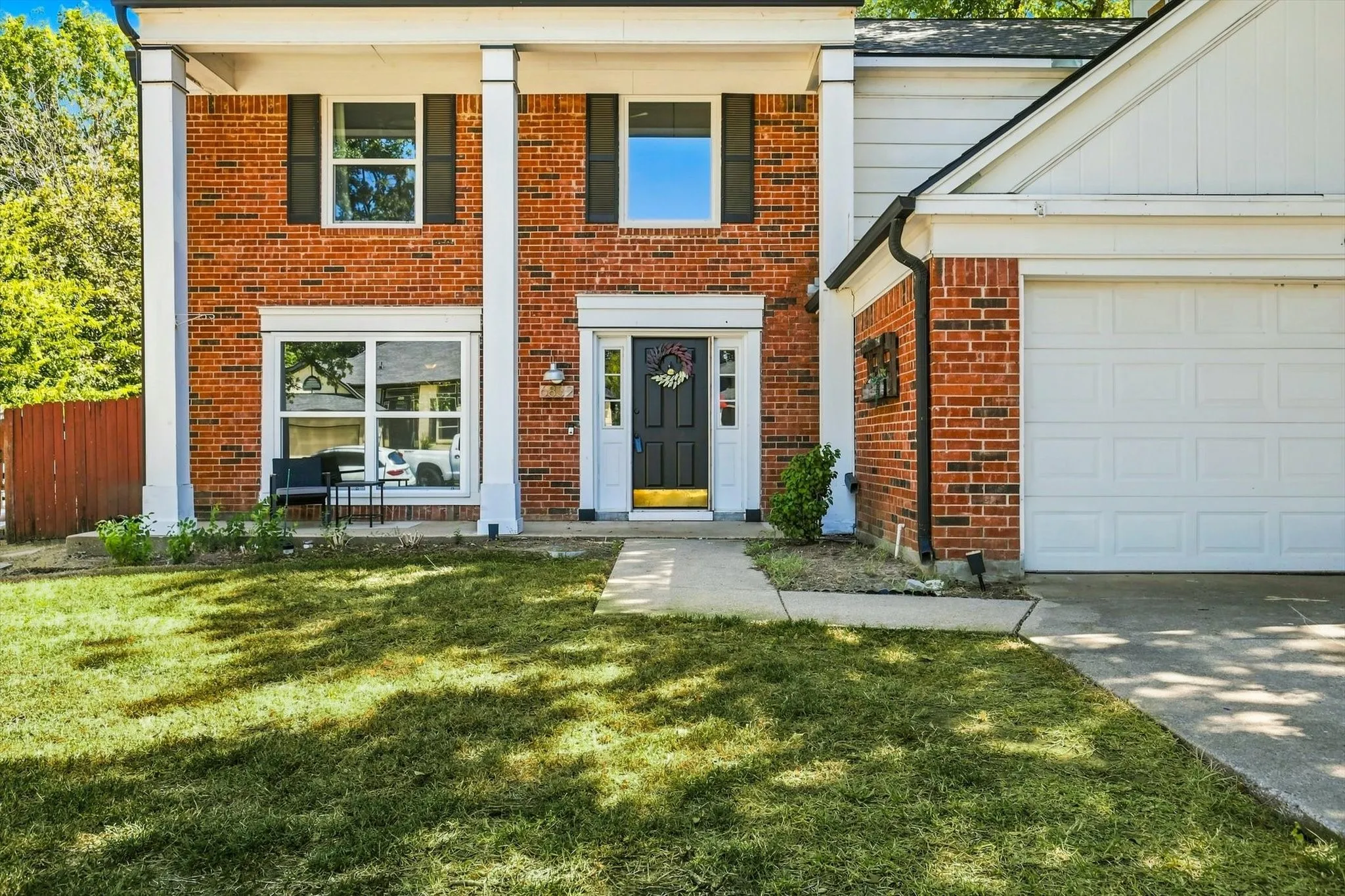 Front Porch Frames this Pretty Home in an Incredible Neighborhood!  The New Windows Throughout is a WIN!