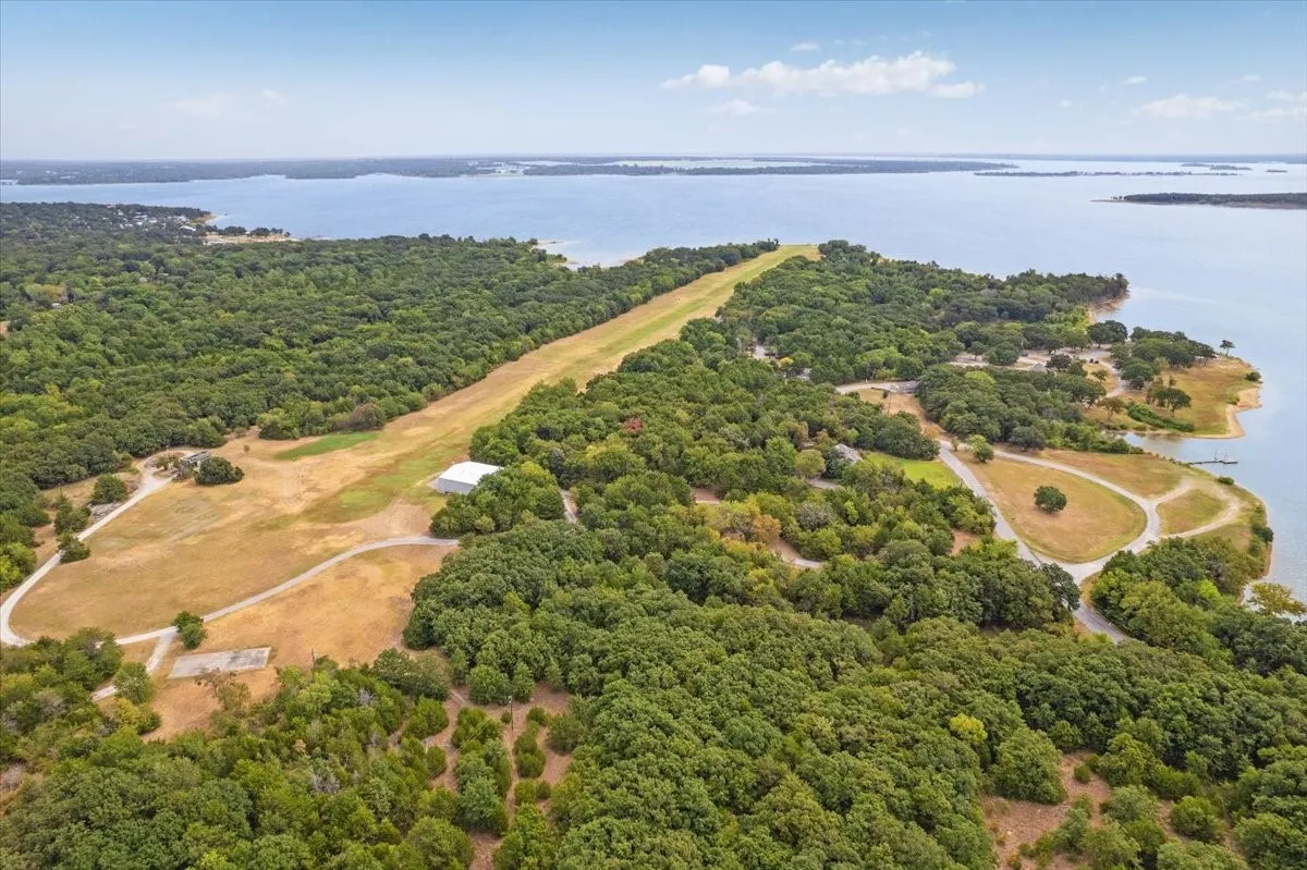 Nearby airstrip surrounded by mature trees