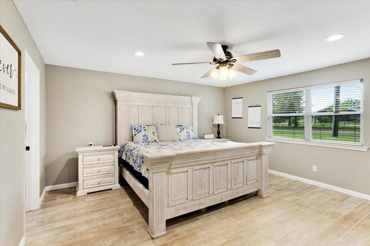 Recessed lighting, ceiling fan, wood-finish flooring, and window with blinds