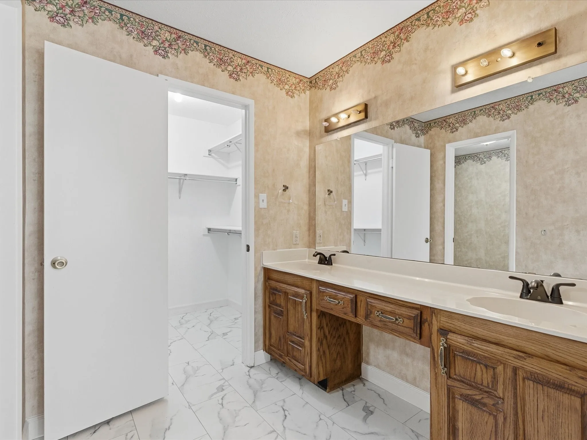 Dual vanity with wood-finish cabinetry and integrated sinks
