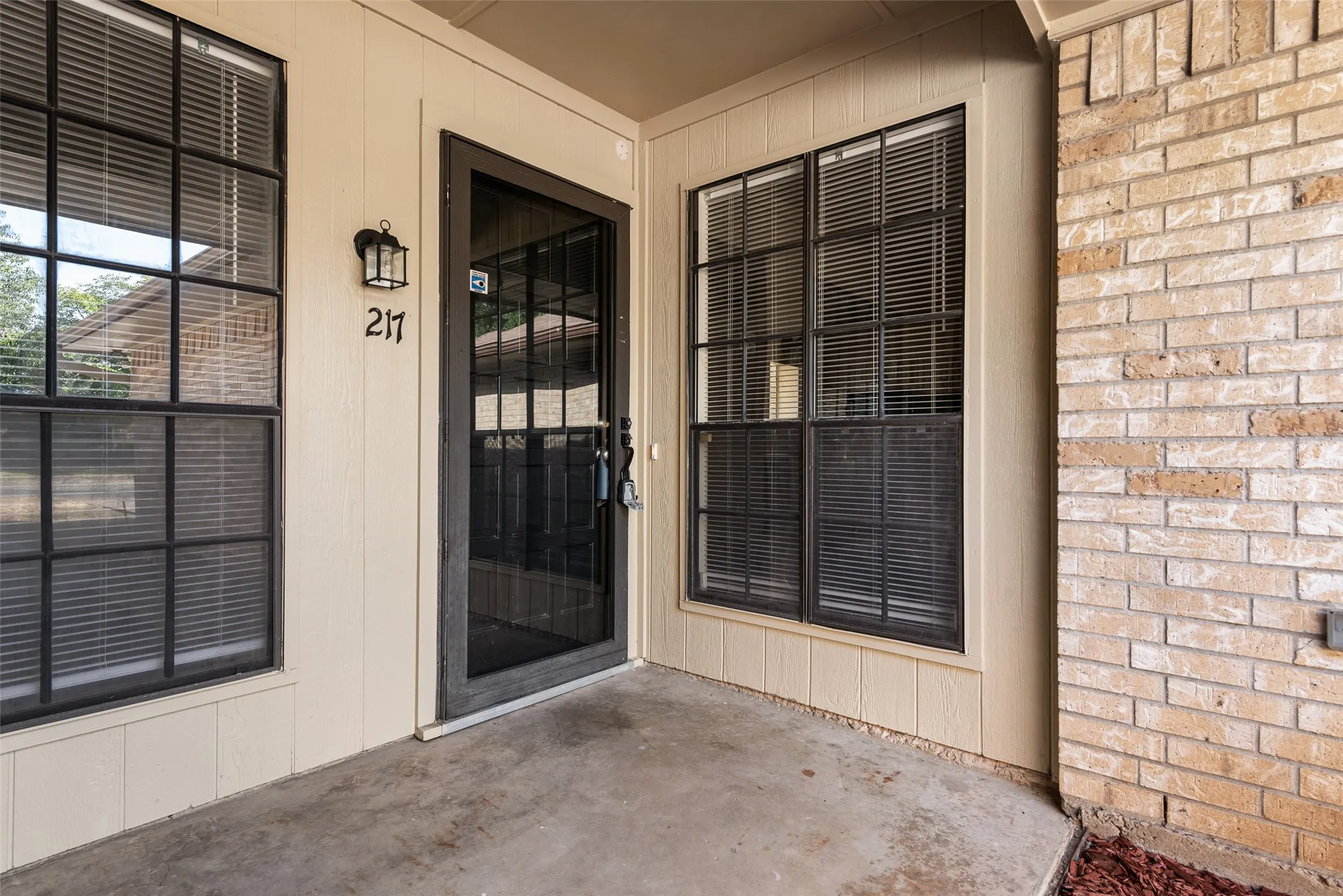 217 Entrance , Brick exterior wall with vertical siding accents