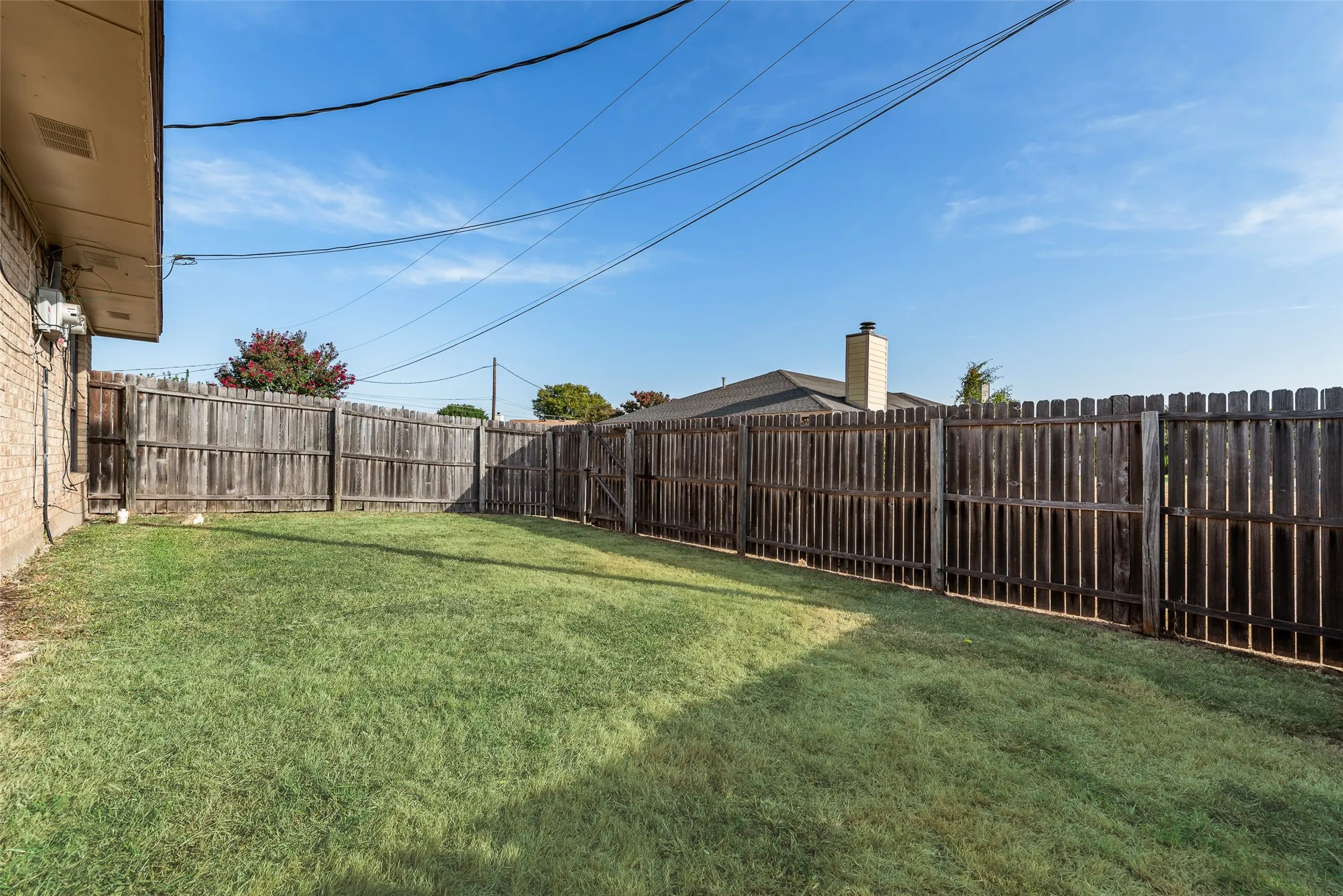 Expansive grass yard enclosed by wood fencing