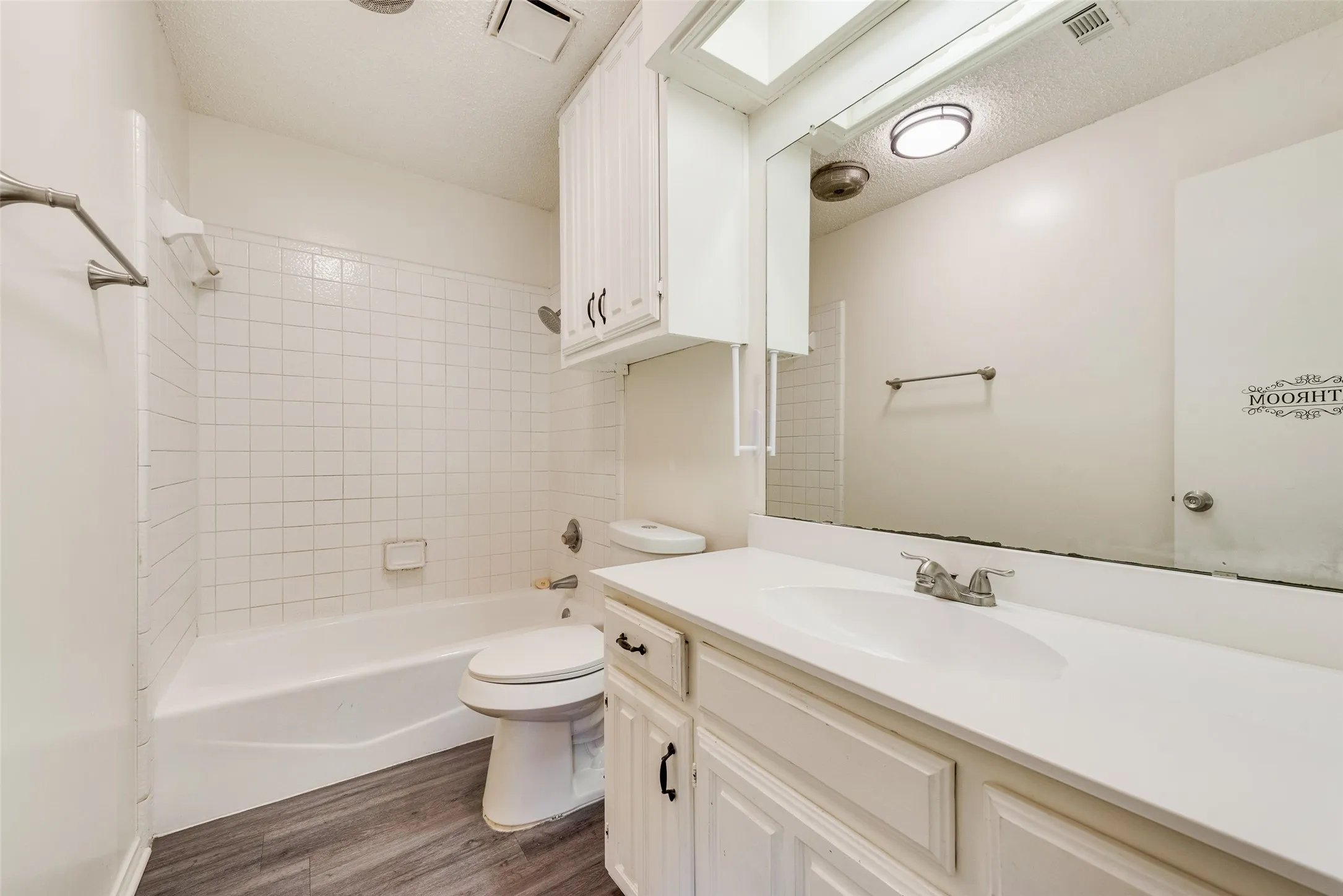 Vanity with integrated sink, chrome faucet, and white cabinetry