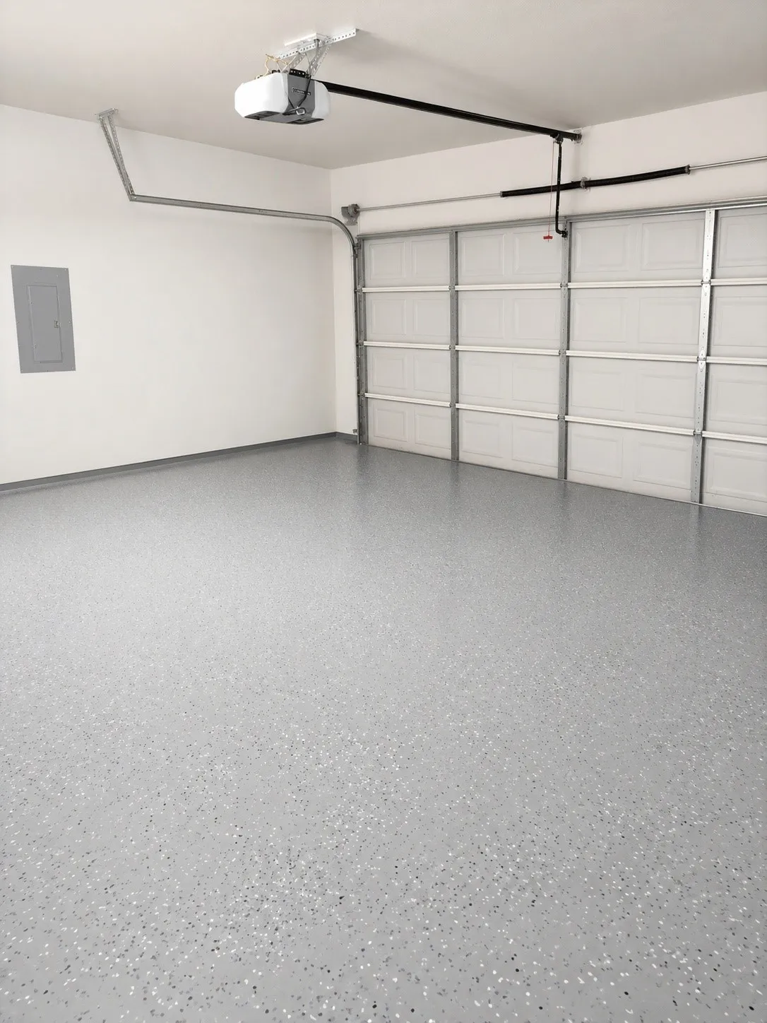 Spacious garage with an epoxy-coated concrete floor, an overhead garage door opener, and a panel-style garage door