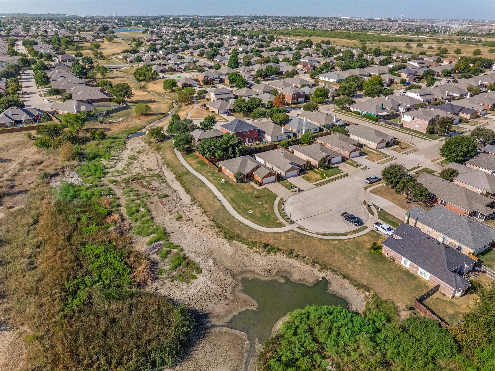 Residential neighborhood with established homes, paved streets, and mature trees