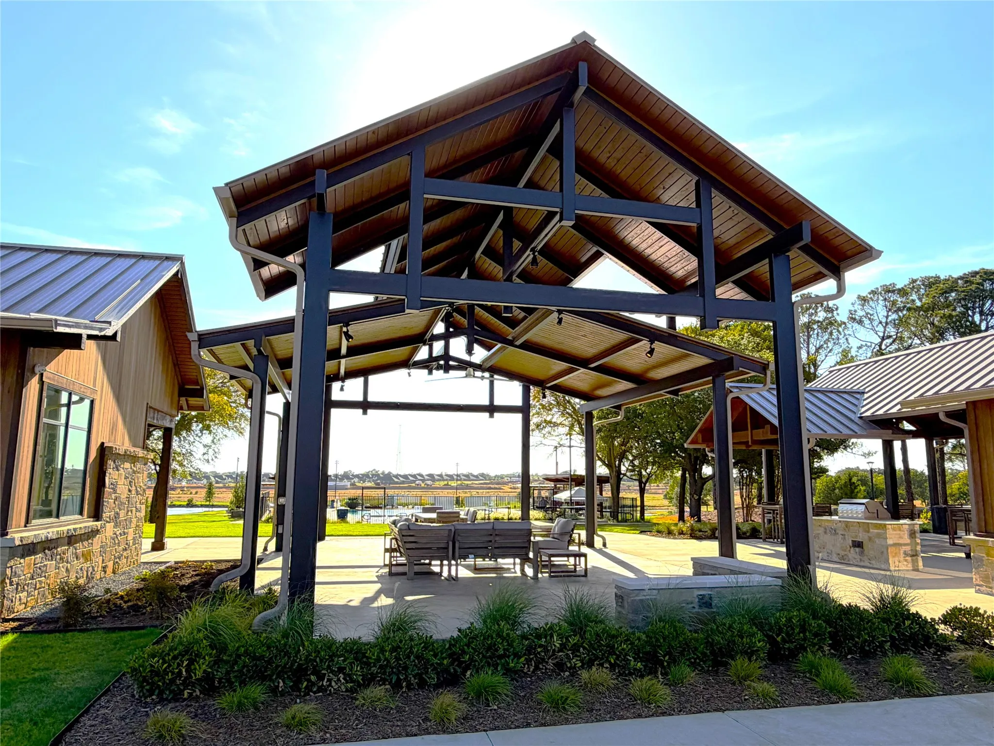 Community outdoor pavilion with a wood-finish ceiling and exposed structural beams