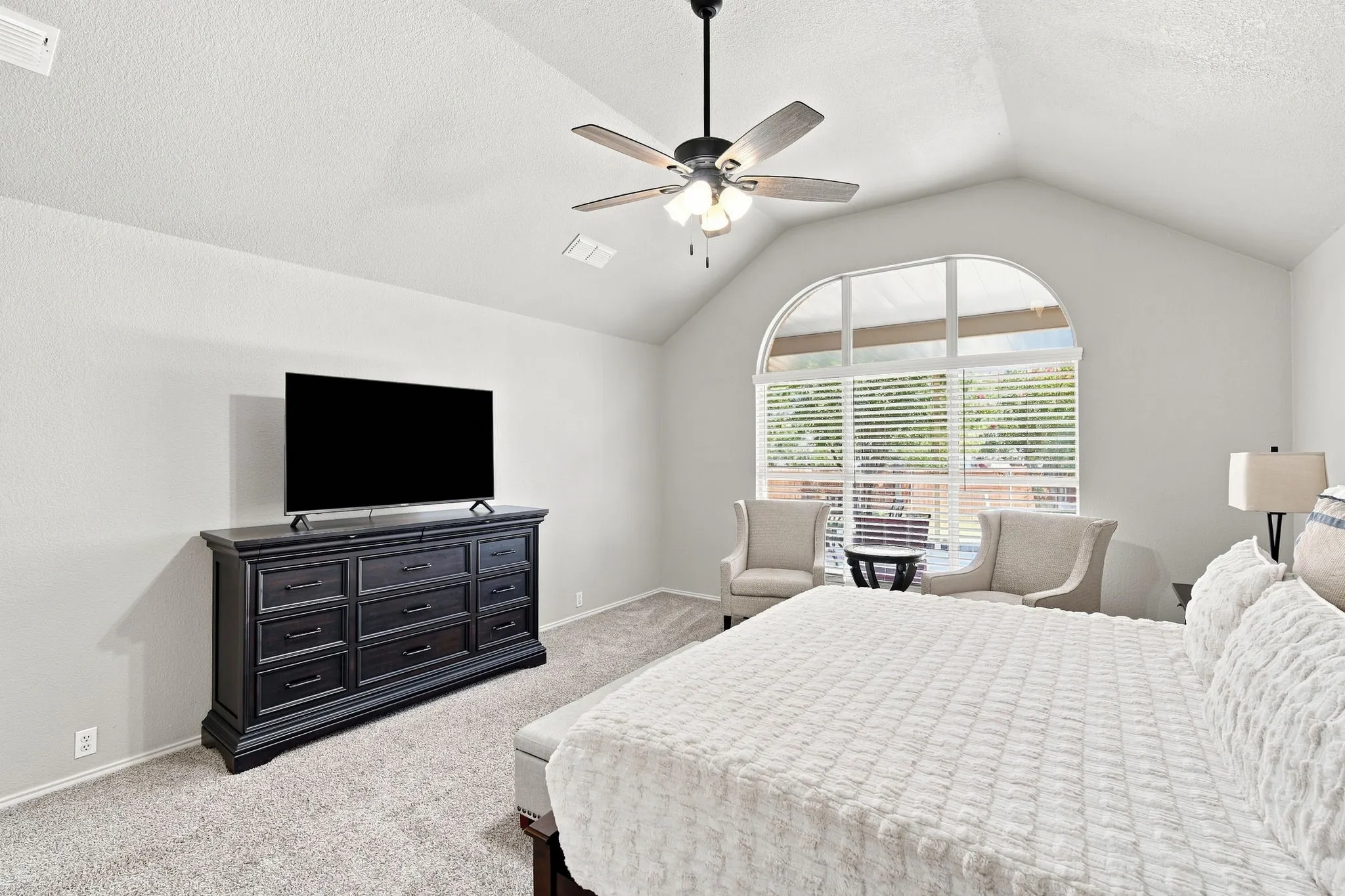 Tall ceilings, ceiling fan and large window add to the relaxation of the owner's retreat.