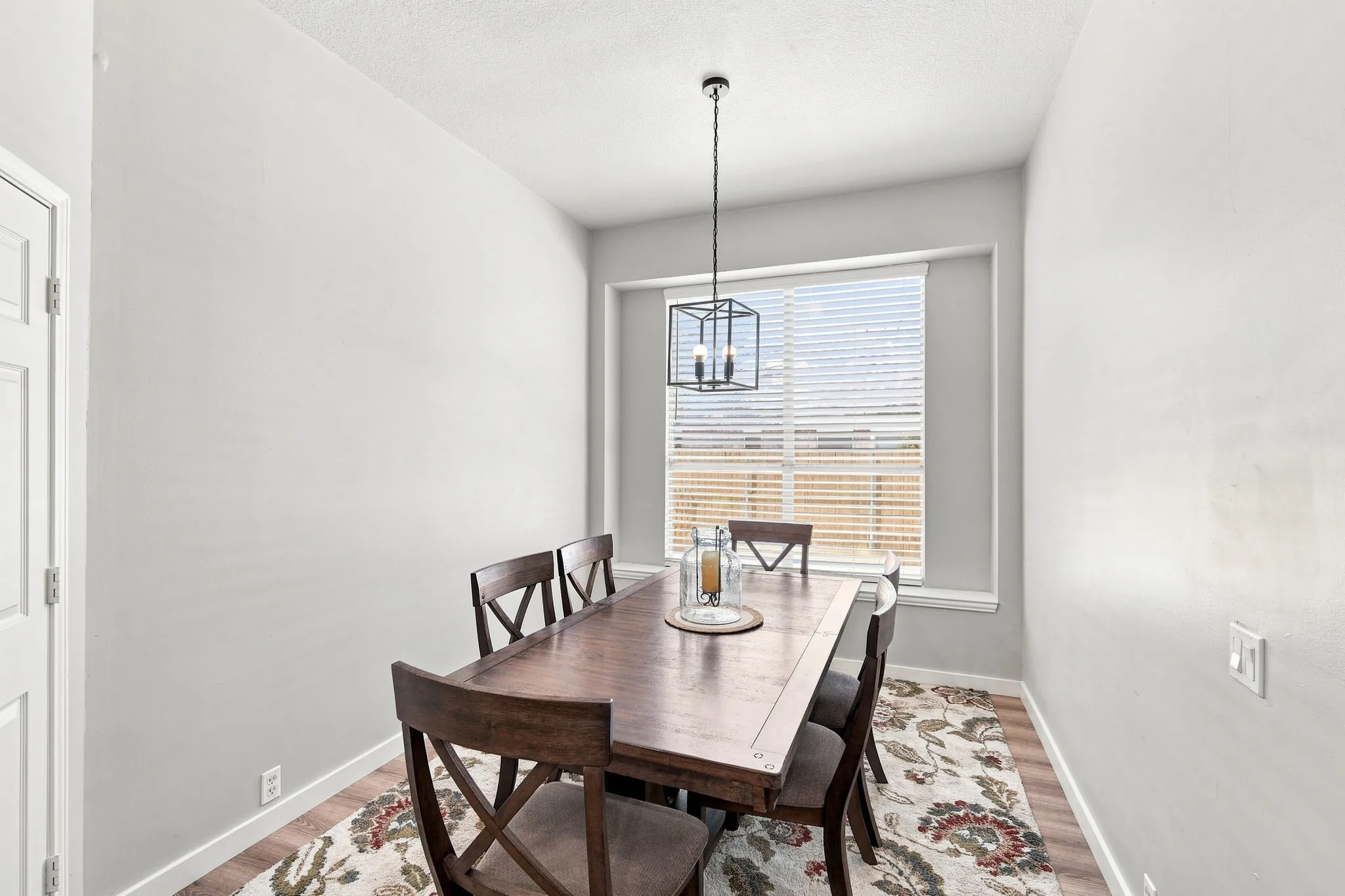 Nice window feature with natural light.  Space for large dining set with room for all.