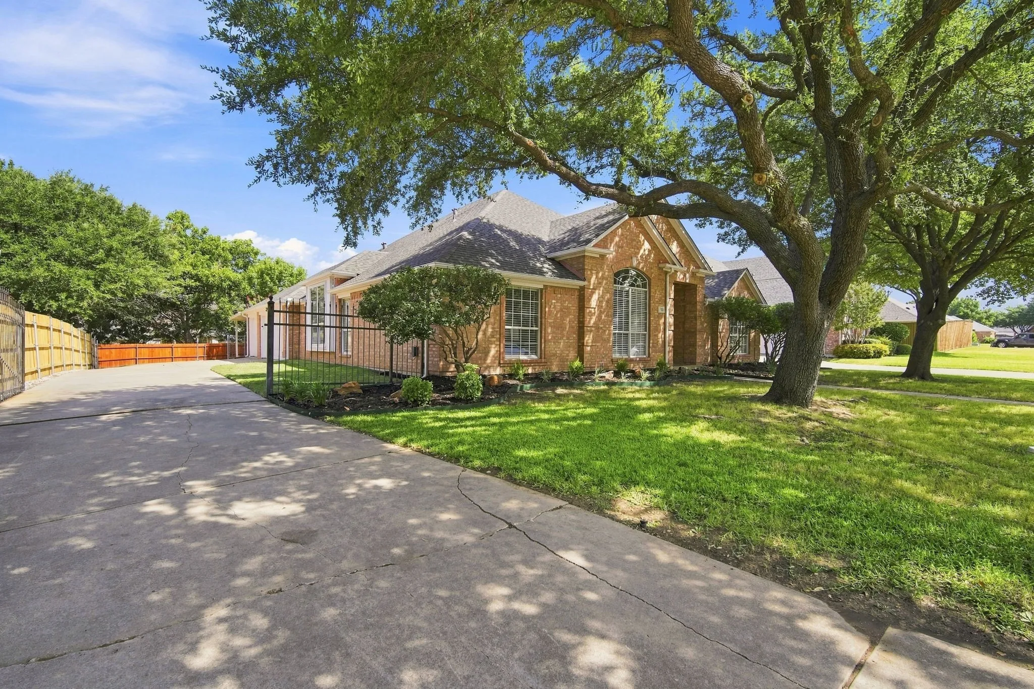 Rod iron electronic gate.  Spacious driveway provides extra space for vehicles and extra space behind the gate for water toys or RV.  THREE car garage, new doors and garage systems.