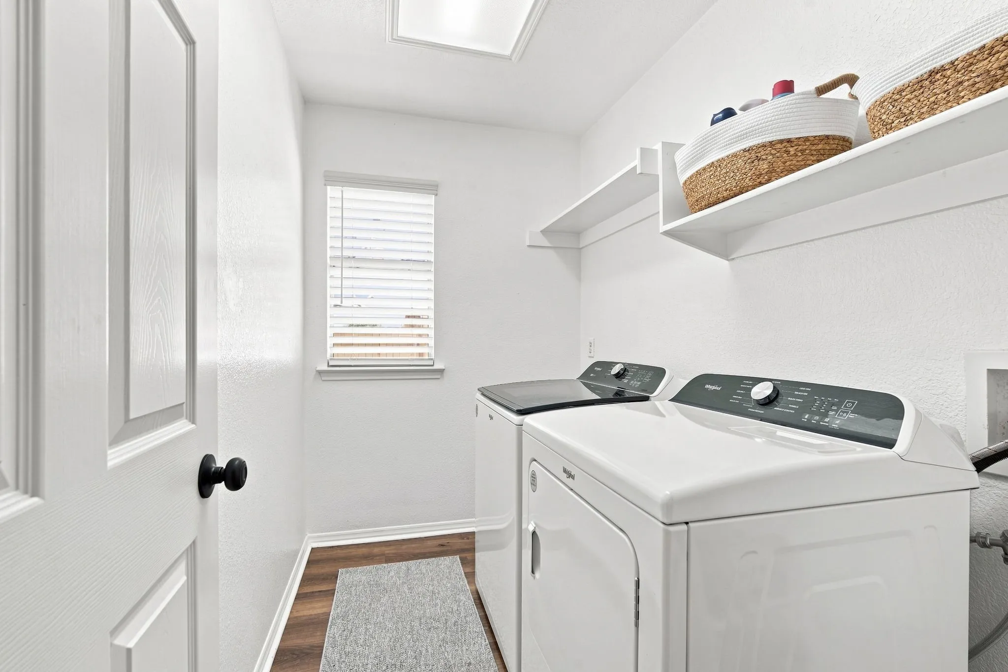Dedicated laundry room with room for storage.