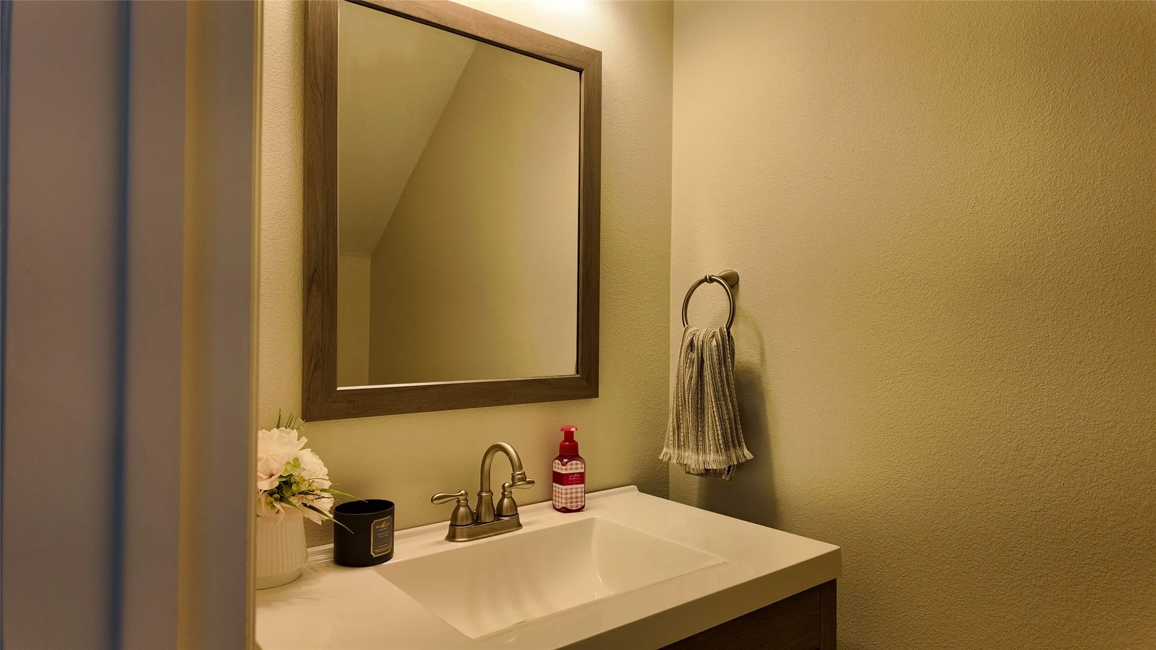Built-in vanity with an integrated sink and a framed mirror