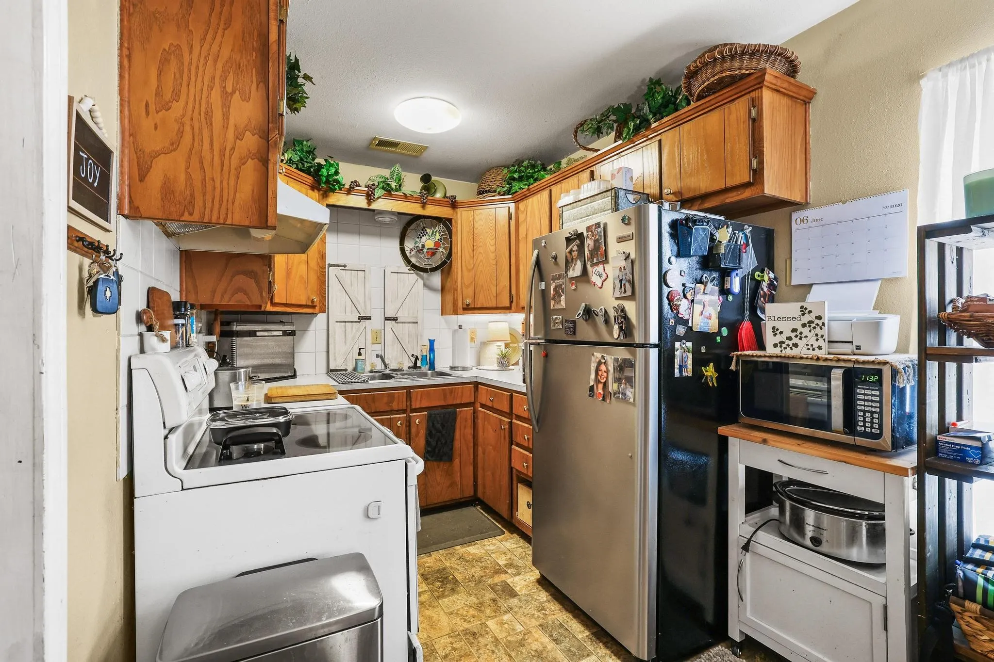 Galley kitchen with dining area at the end of the room by the living room.