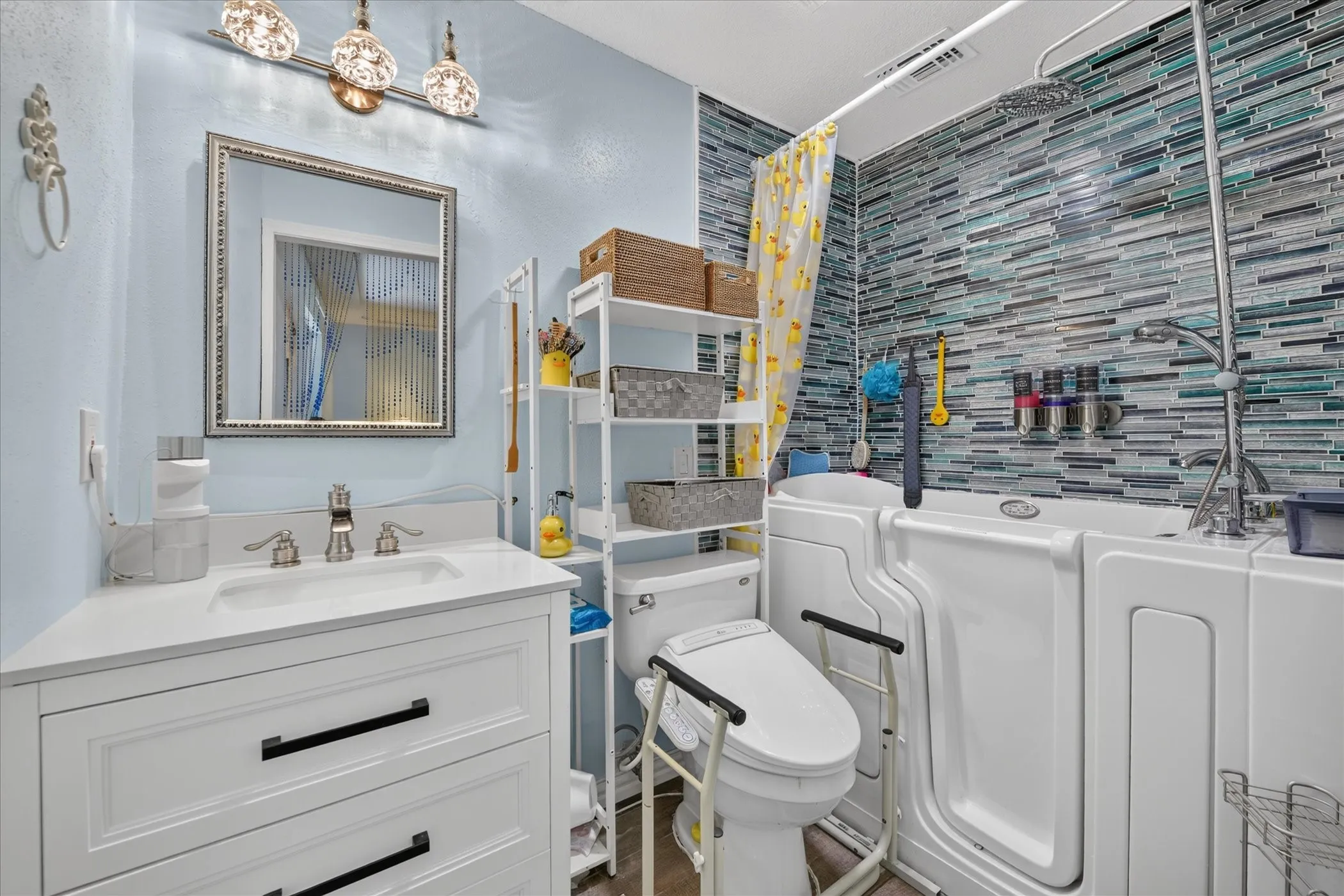 White vanity with integrated sink and brushed nickel faucet