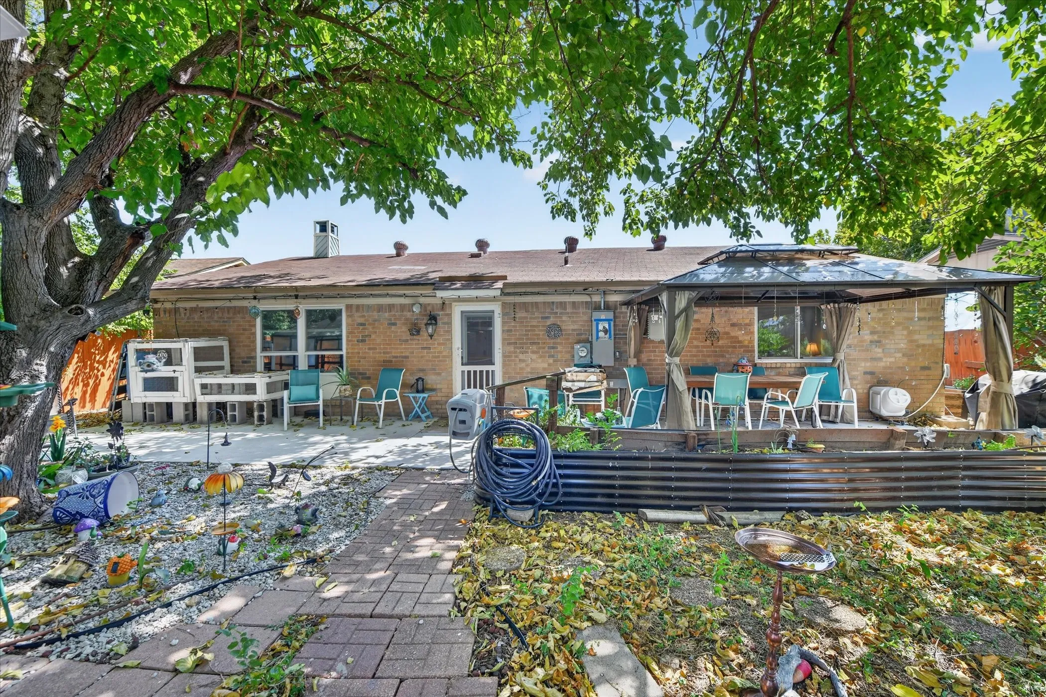 Brick exterior with a covered patio area and a separate concrete patio