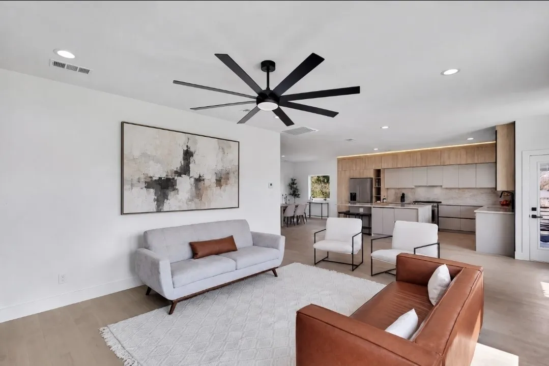 Open-concept living space featuring wood-finish flooring, recessed lighting, and a modern ceiling fan