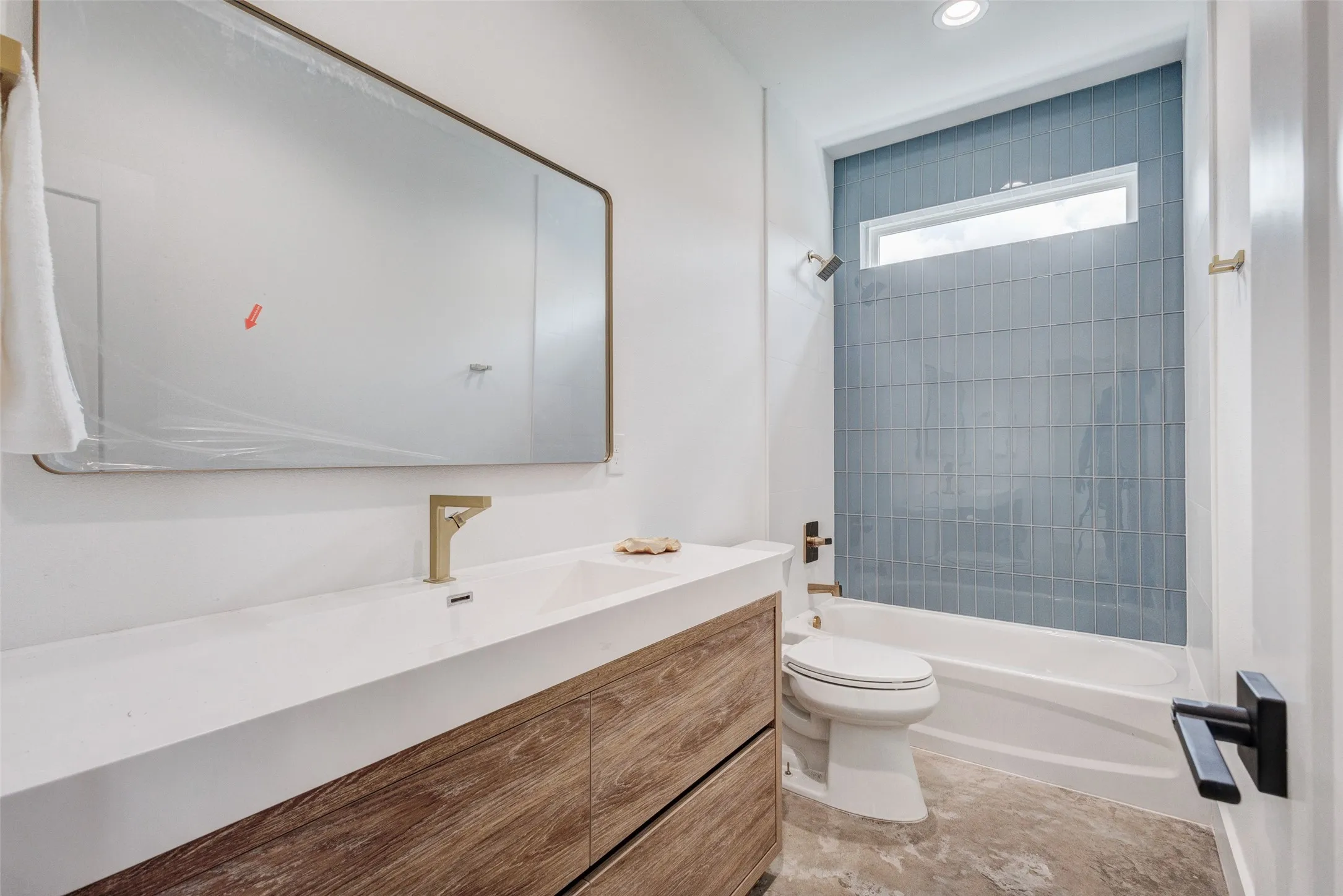 Integrated vanity with a white countertop and wood-finish cabinetry