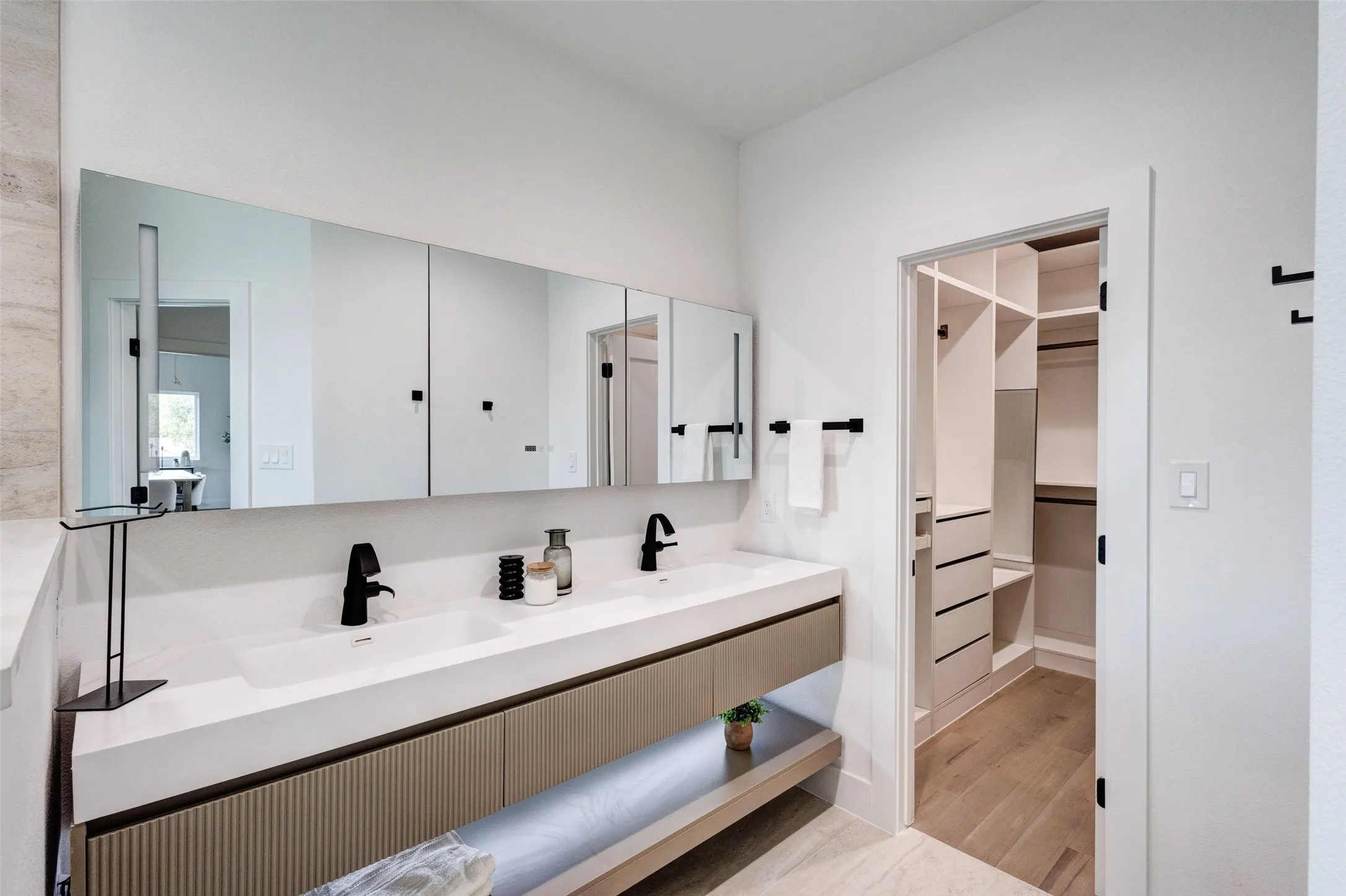 Dual-sink vanity with matte black faucets and integrated storage