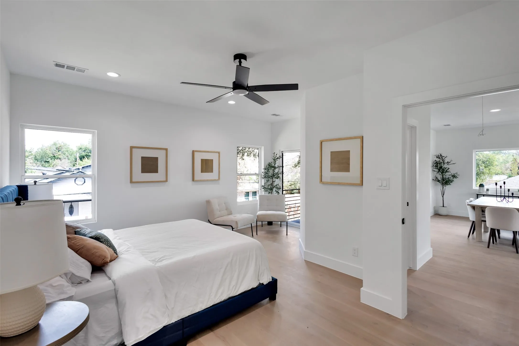 Light wood-finish flooring, recessed lighting, and a ceiling fan with integrated lighting