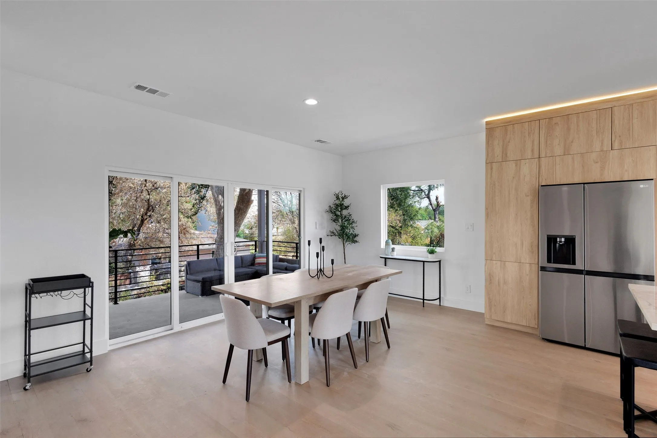Recessed lighting, wood-finish flooring, full-height cabinetry, and stainless steel appliances
