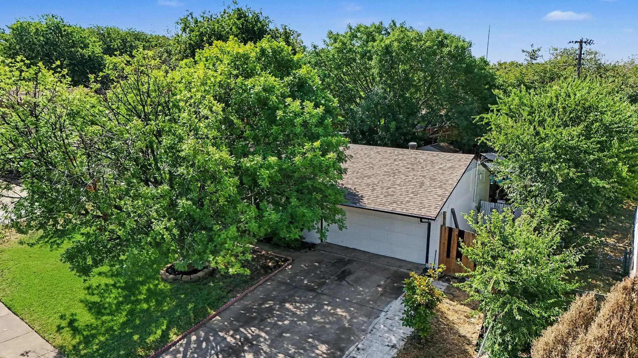 Asphalt shingle roof with a single-car garage and concrete driveway