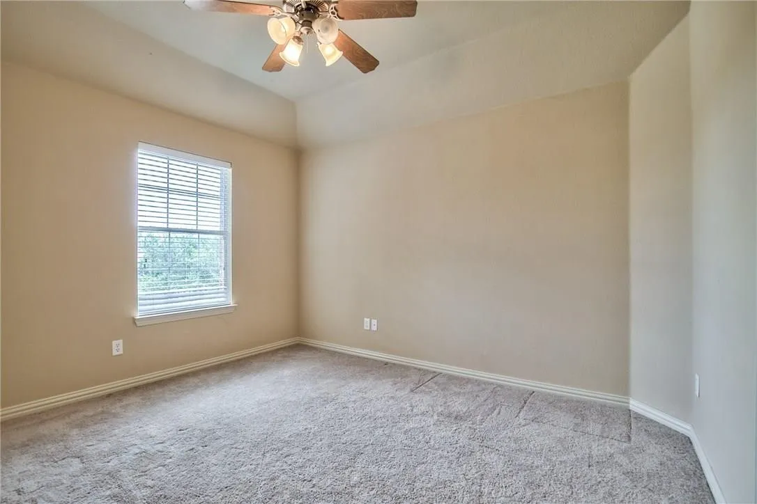 Neutral-toned walls complement the carpeted flooring