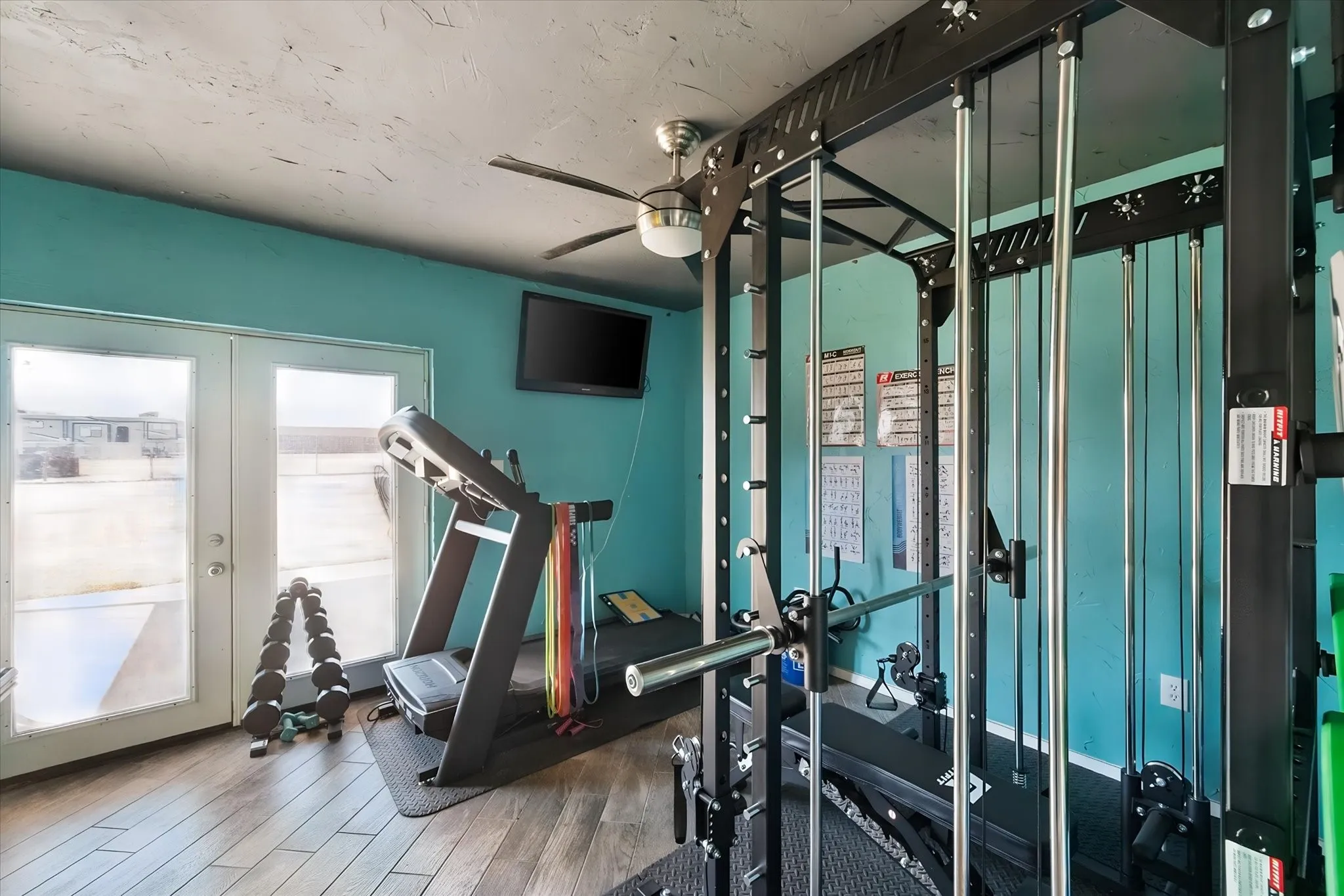 Area perfect for your personal work out room.  Wood-finish flooring with a ceiling fan