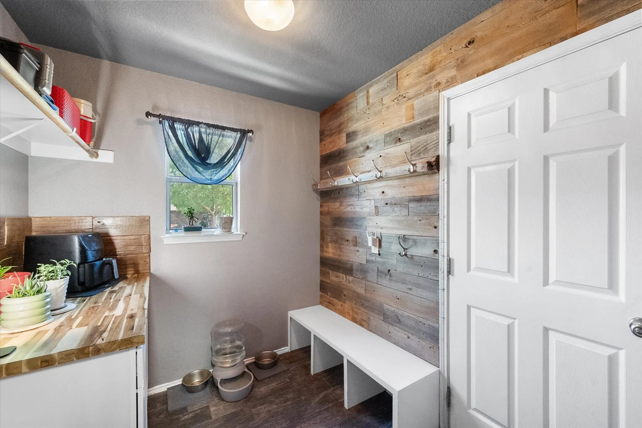 Mudroom off attached garage.  Perfect place to hang your coats shoes and backpacks.  Cabinet provides plenty of storage