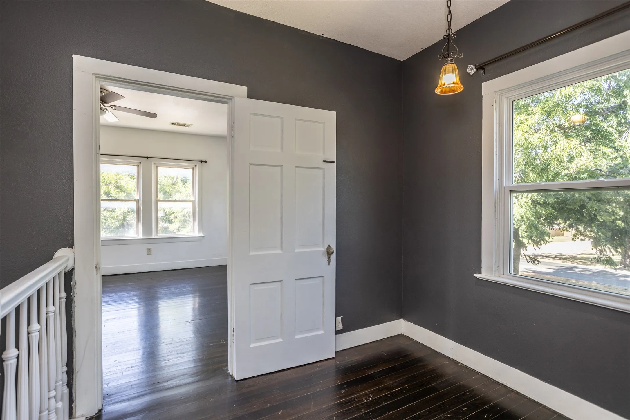 Dark wood-finish flooring with white trim