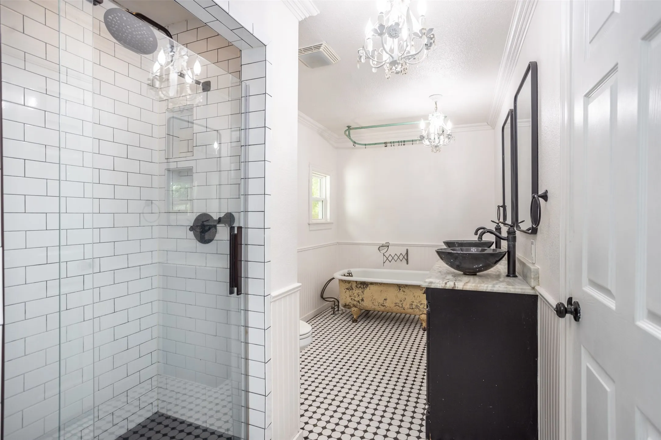 Walk-in shower with subway tile surround and dark hex tile floor