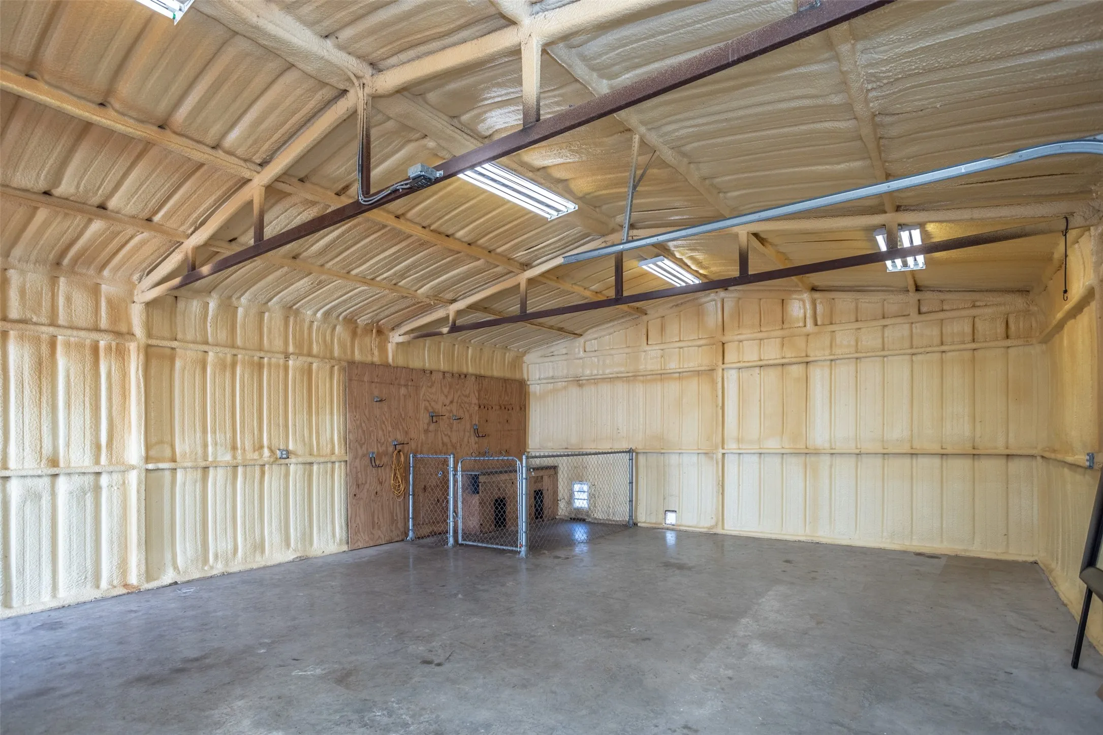Inside workshop Spacious interior with concrete flooring and exposed structural beams