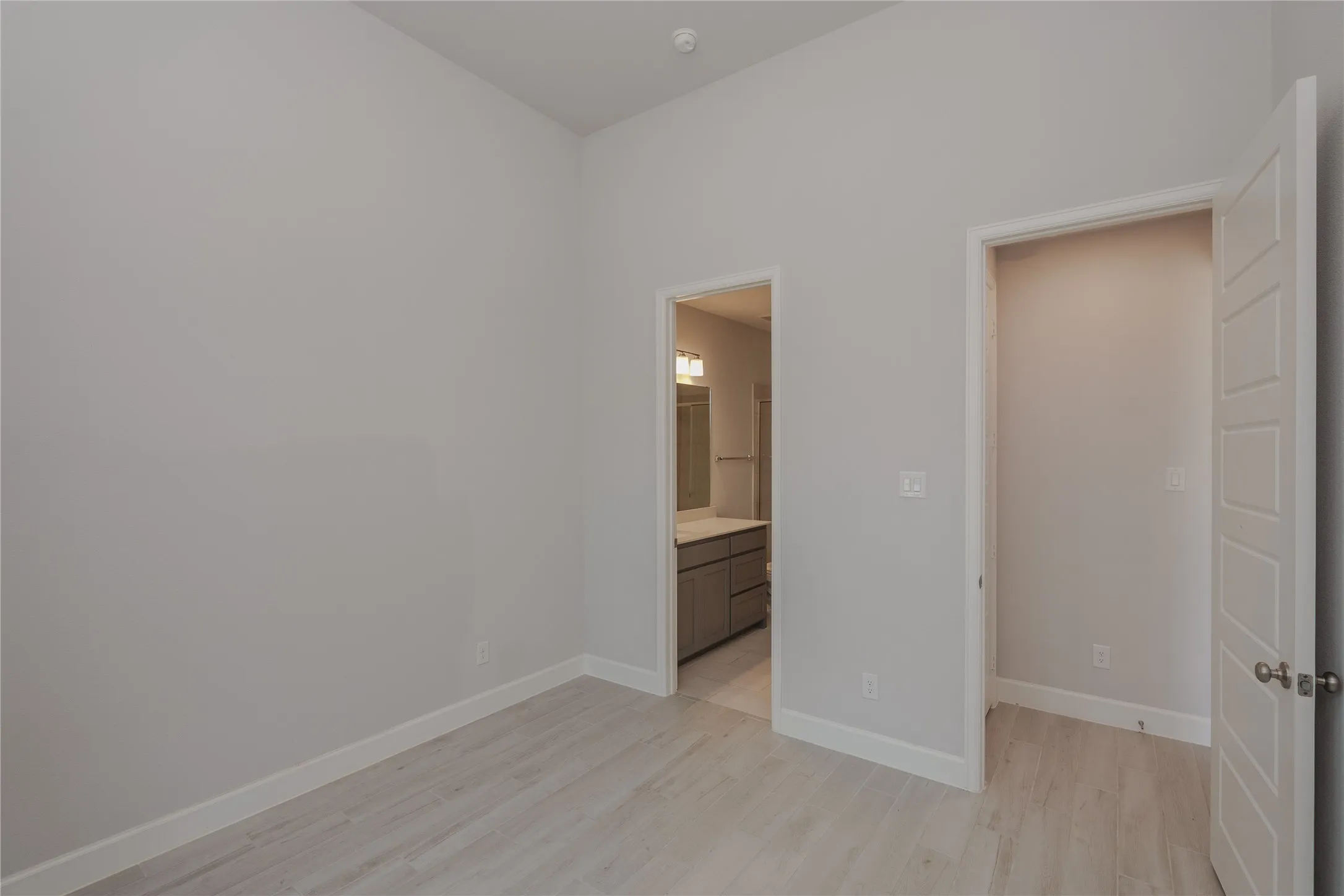 Light-toned wood-finish flooring complements neutral wall tones