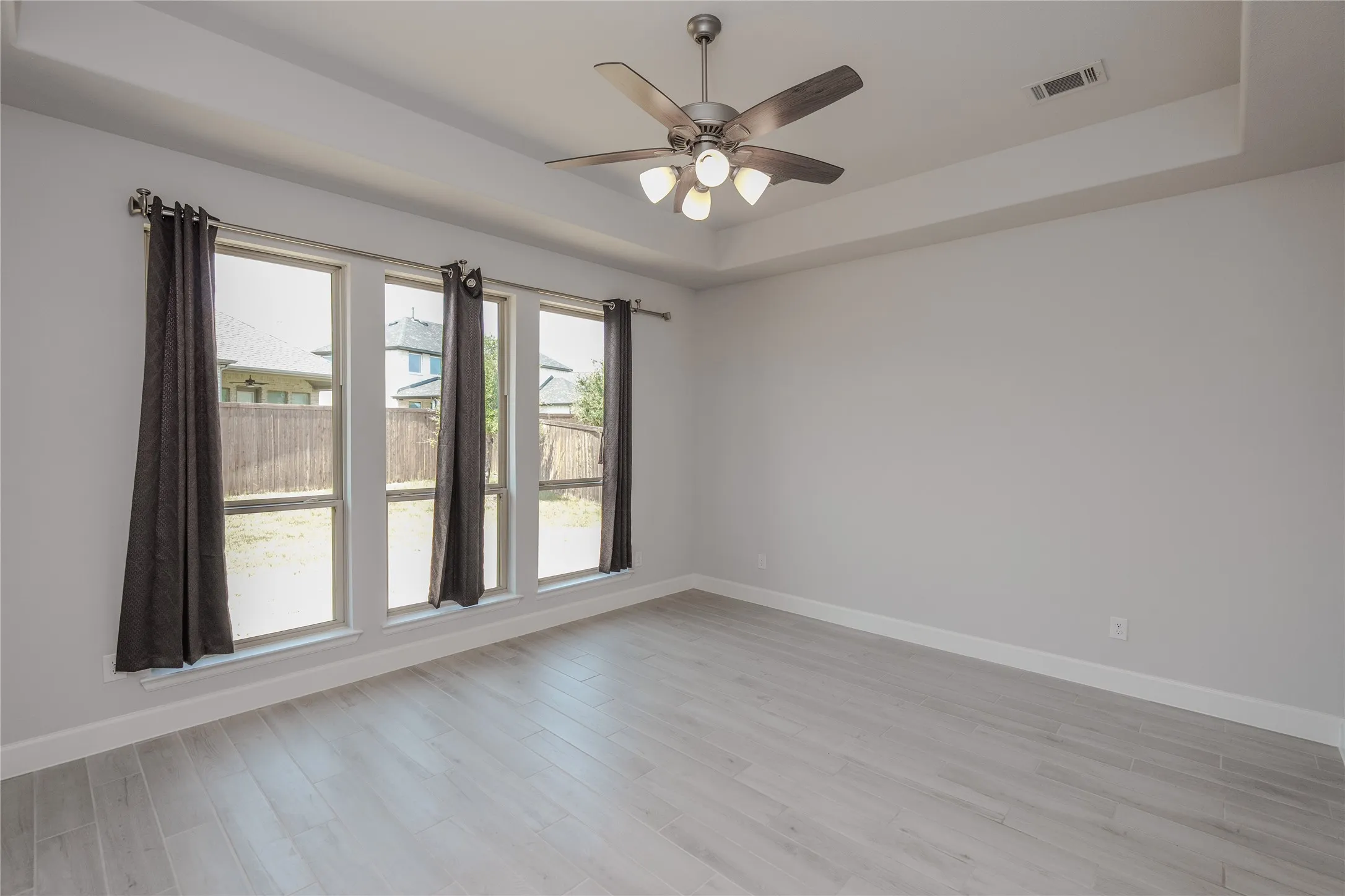 Bright, open room flooded with natural light through multi-panel glass doors and windows