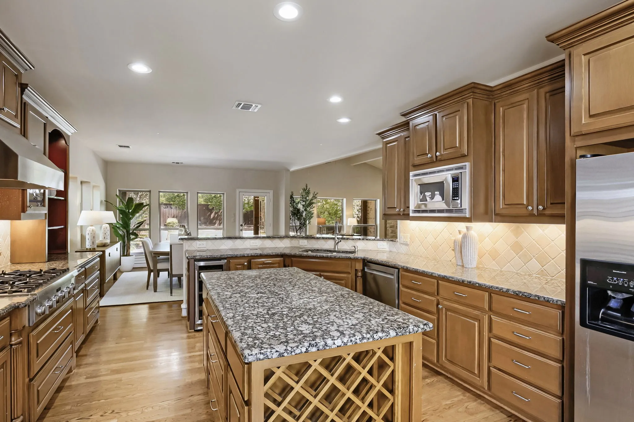 Granite counters and center island with wine rack and wine fridge.