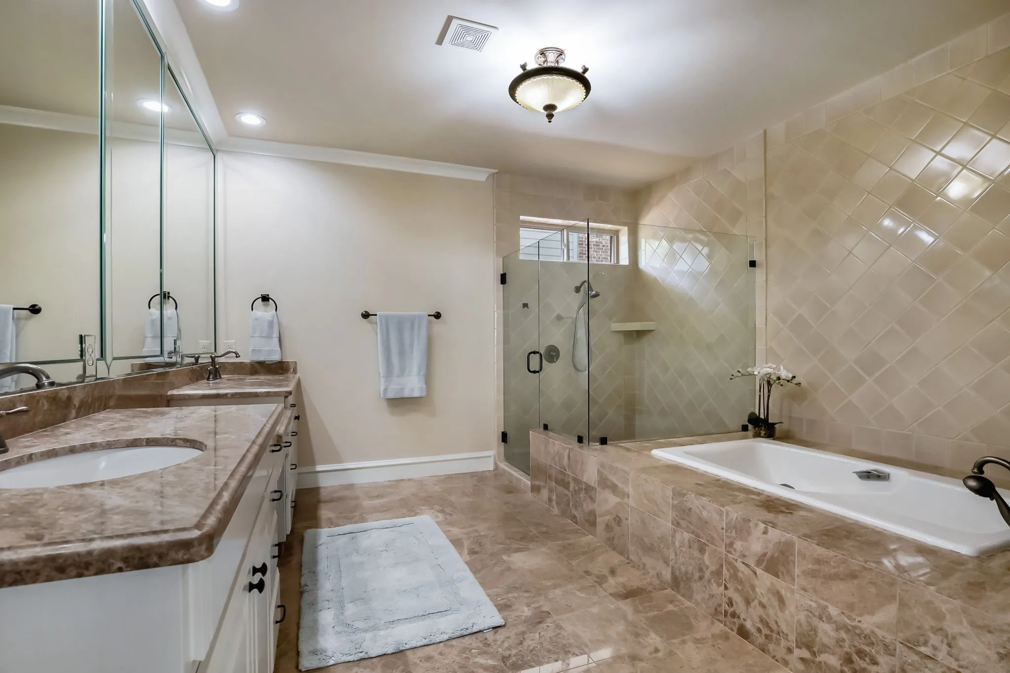 Oversized garden tub and glass shower.