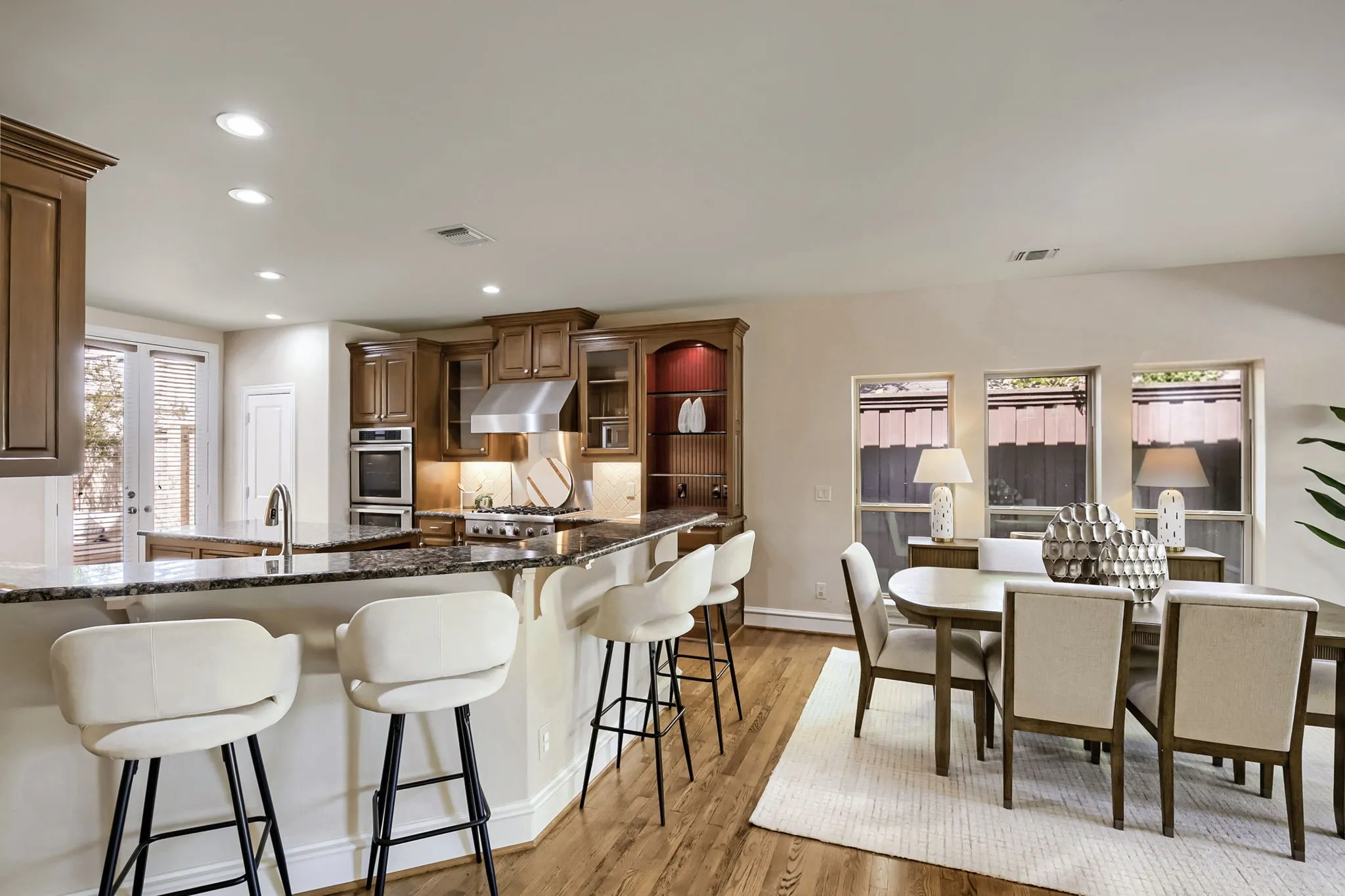 Kitchen has spacious bar and opens to large dining area.