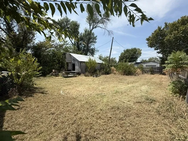 View of large backyard behind home